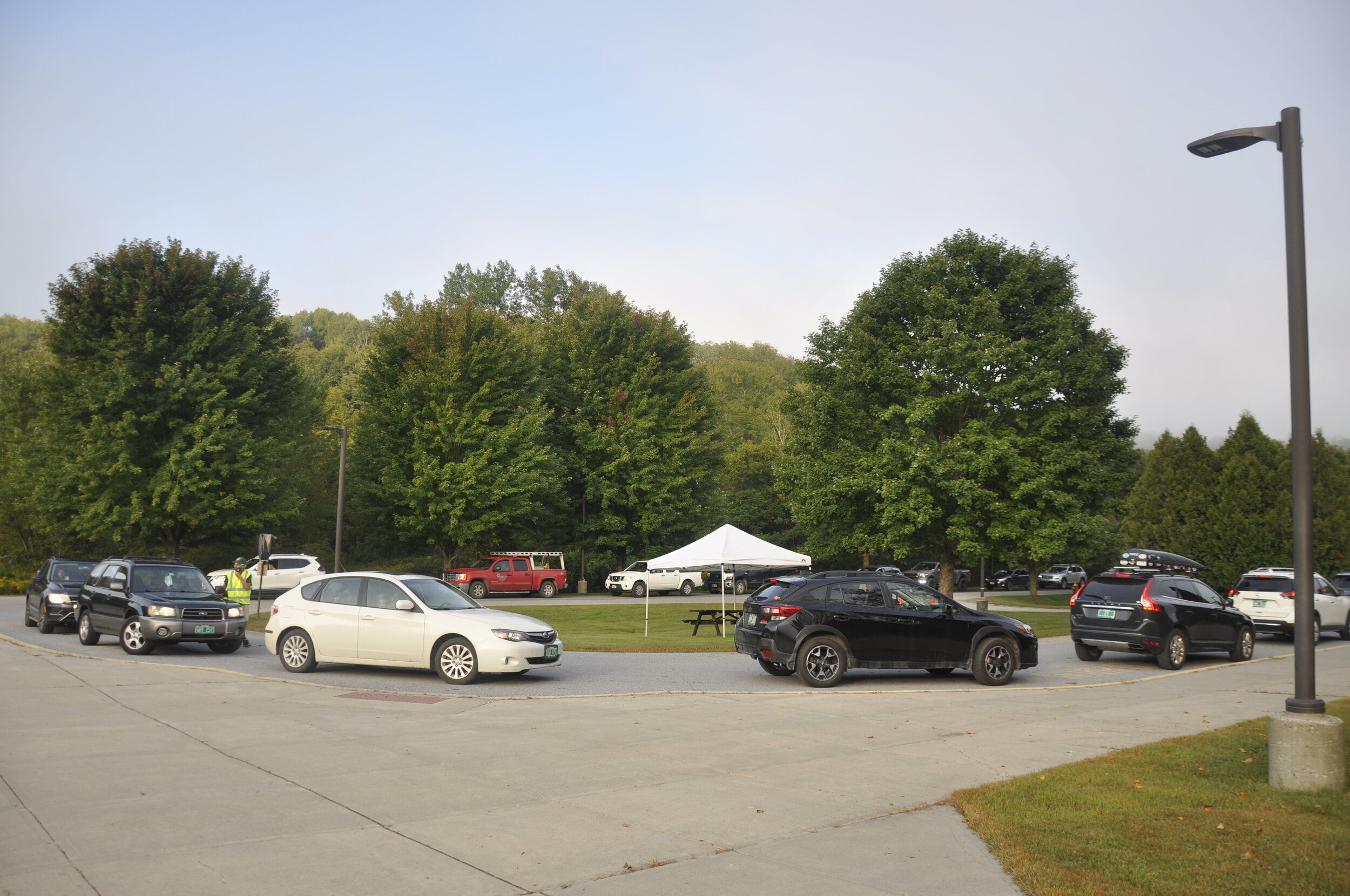   Parents line up vehicles in the parent loop but students don't get out until they reach the health screenings by the gym. Photo by Lisa Scagliotti.  