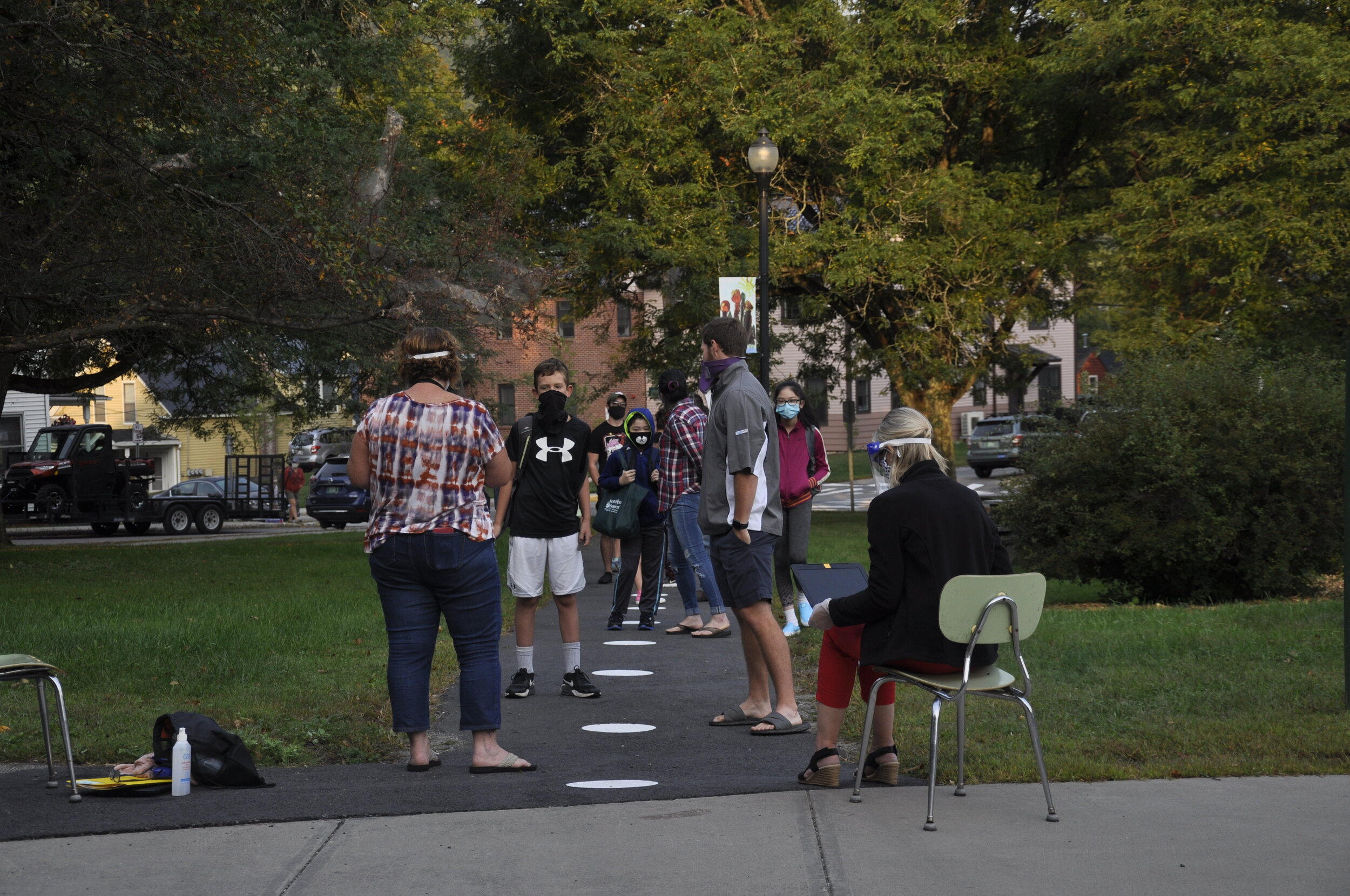   School staff worked in pairs asking questions, recording answers on laptops, and taking temperatures. Photo by Lisa Scagliotti.  