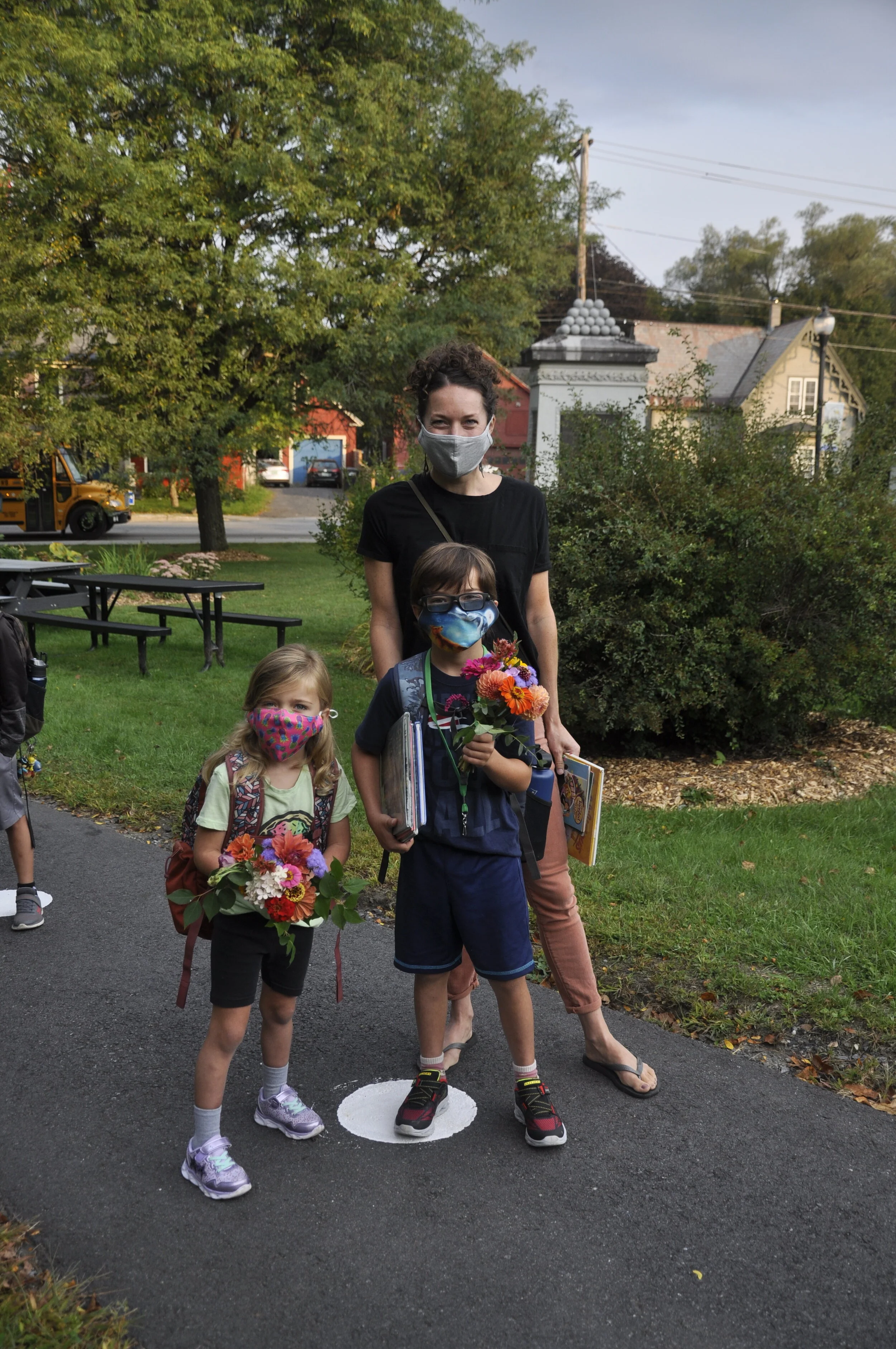   Kindergartner Hailey Antell (left) and her brother Mason, a second-grader, stopped with their mom Martine for flowers for their teachers on their way to school Tuesday morning. Photo by Lisa Scagliotti.  