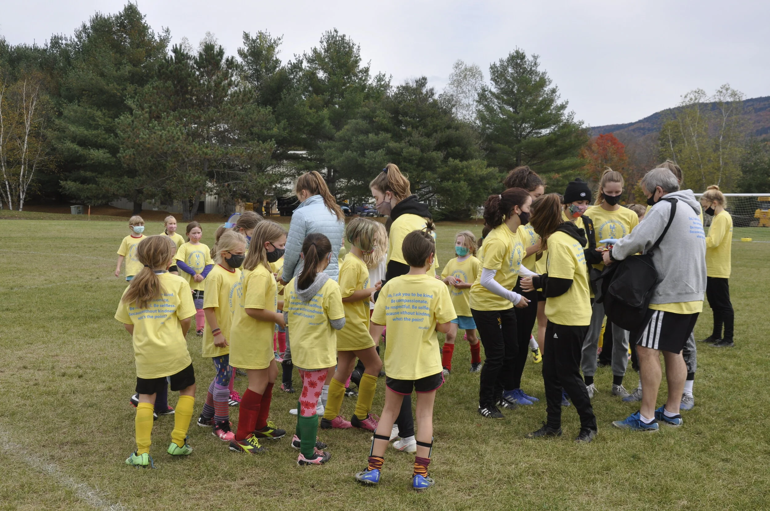   Coach Mike Vasseur divides the candy stash among the high school players to distribute. Photo by Lisa Scagliotti.  