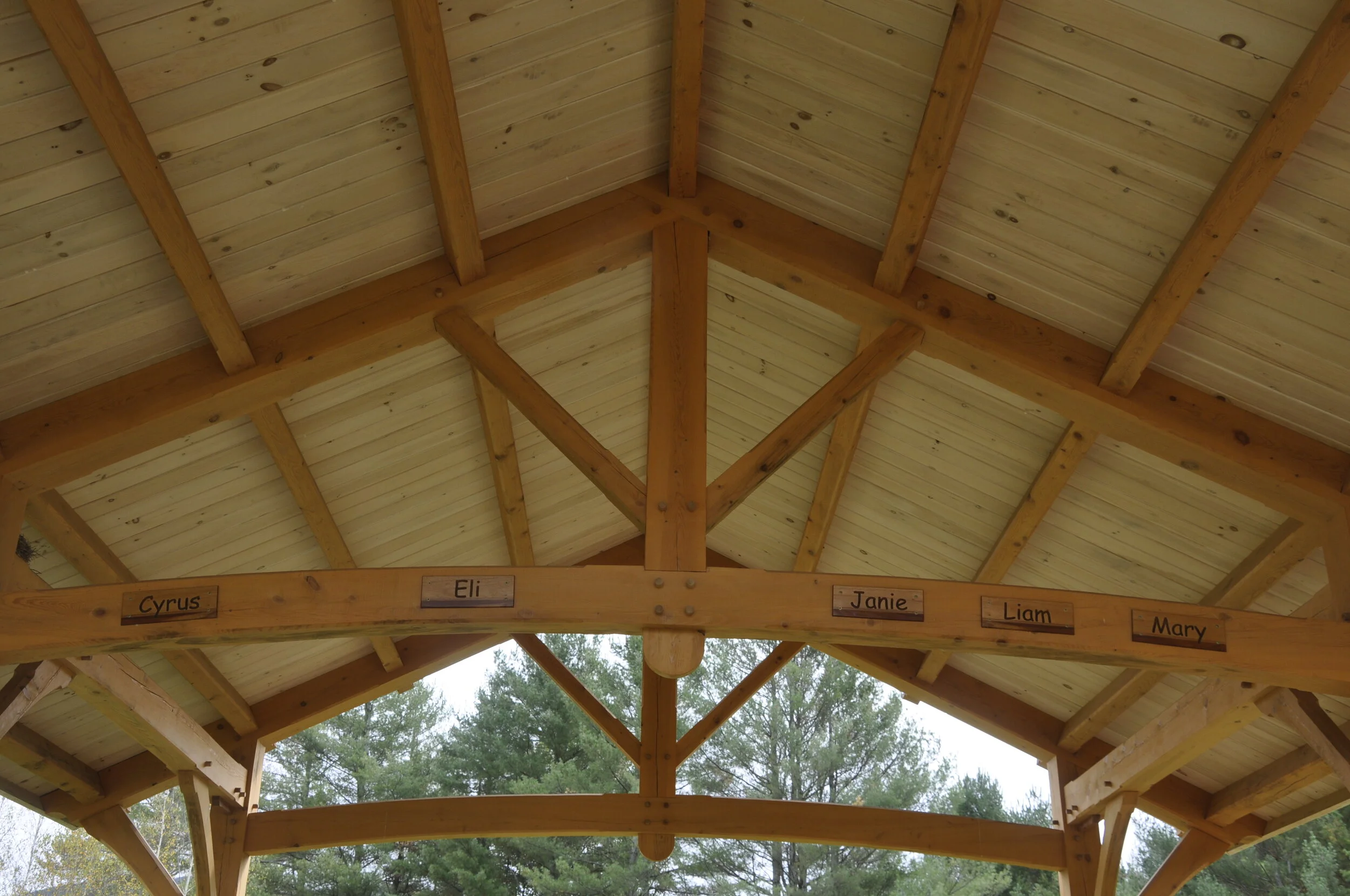   The overhead beam in the pavilion at Mad River Park bears the names of the five students who died in the Oct. 8, 2016 car crash. Benches also have dedications to their memory. Photo by Lisa Scagliotti.  