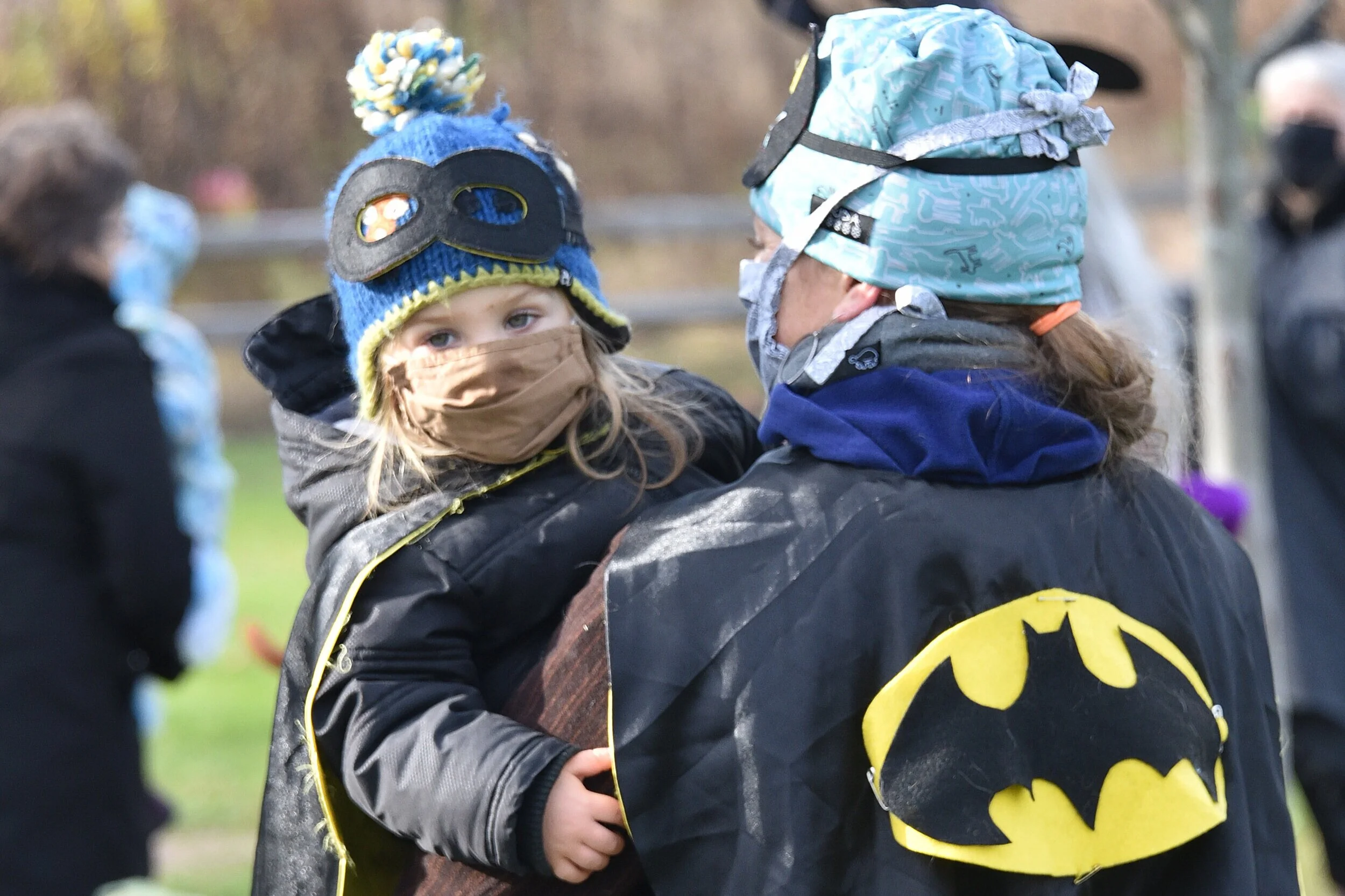 Tots and their adults mask up for daytime outdoor Halloween party