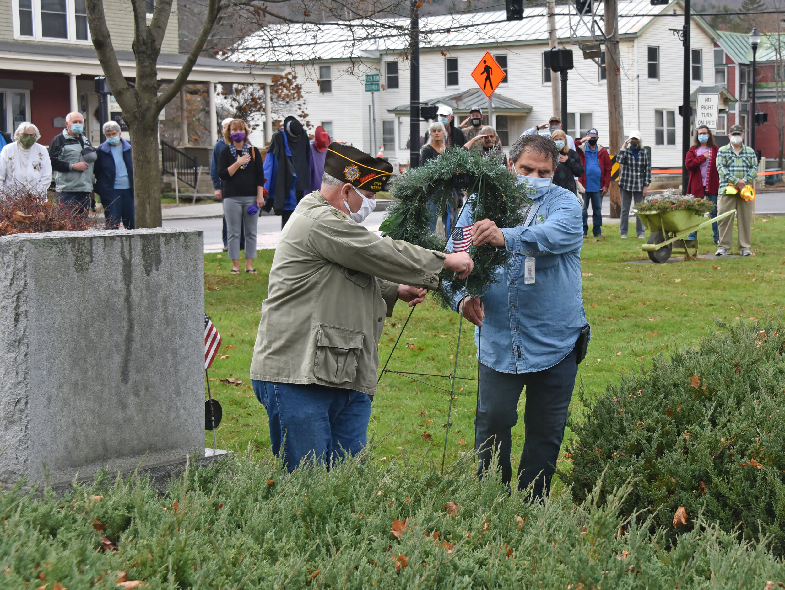  Marcel Mongeur and Brian Larrabee position a wreath at the memorial monuments. Nov. 11 as Veterans Day recognizes all who have served in the armed forces in all wars. Photo by Gordon Miller. 
