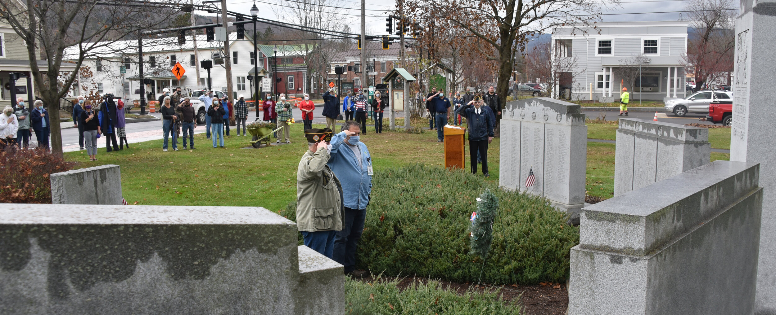   Marcel Mongeur and Brian Larrabee salute after the memorial wreath is in place. Photo by Gordon Miller.  