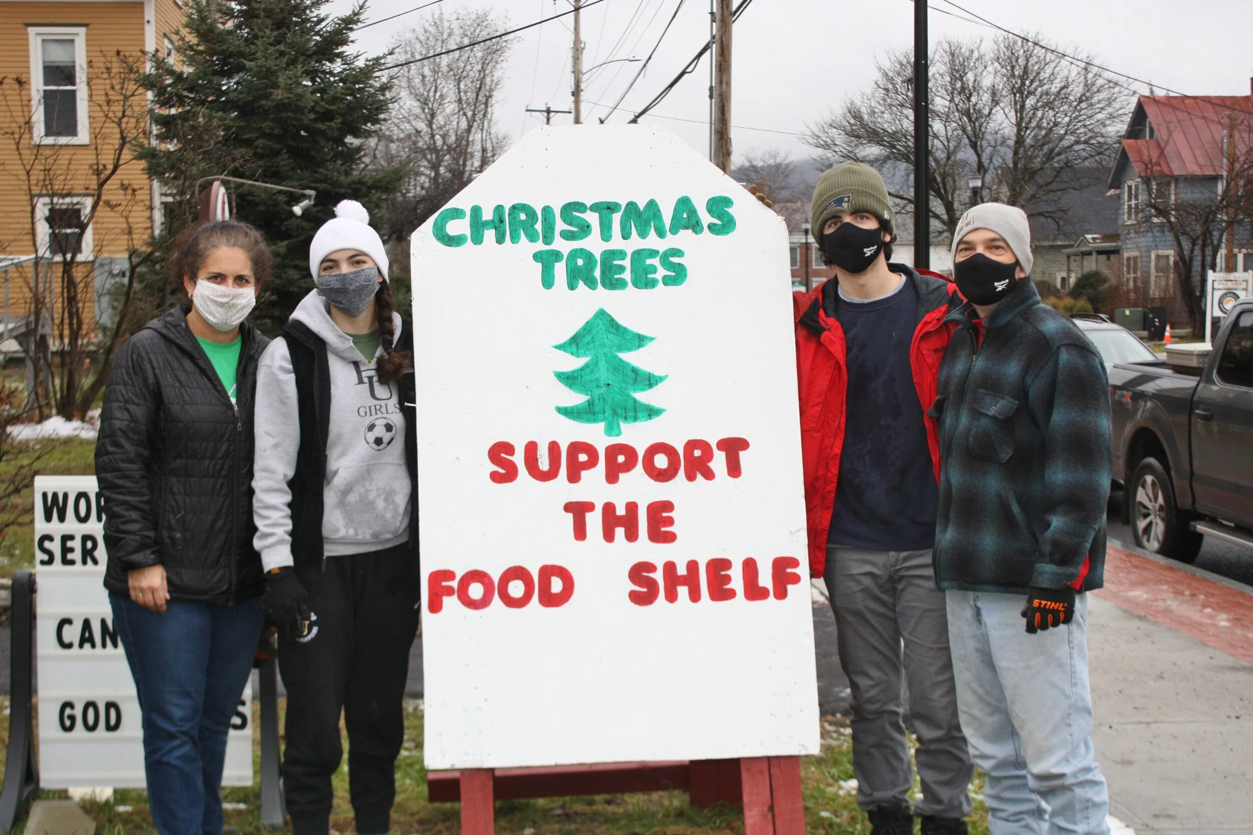   The Proteau family spruced up the familiar tree sale sign. Left to right: Leslie, Ashley, Andrew, Brian Proteau. Photo by Skip Flanders.  