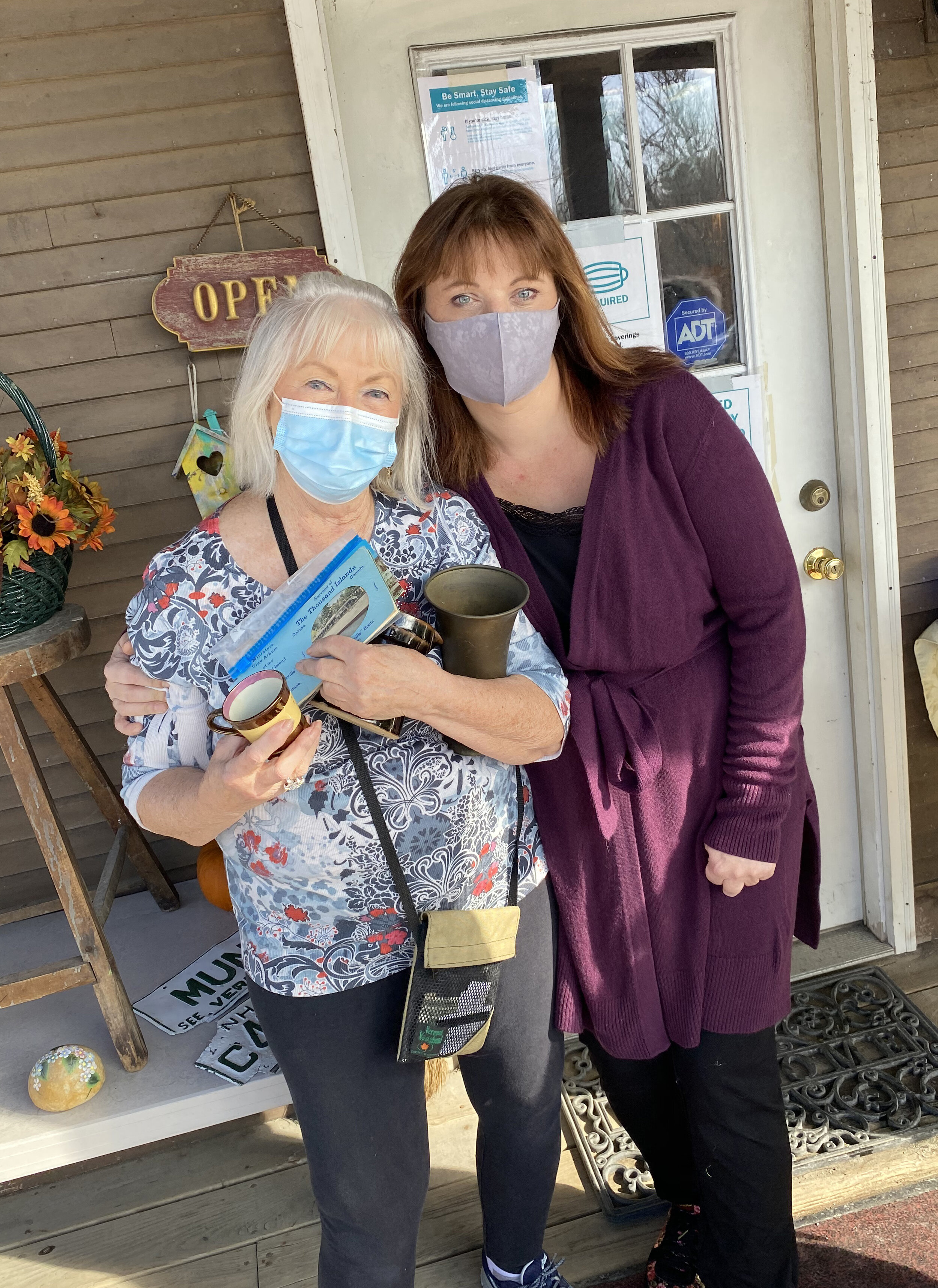   Store owner Barbara Parker and daughter, Karen, take a break outside during the clearance sale at Early Vermont Antiques. Photo by Gordon Miller.  