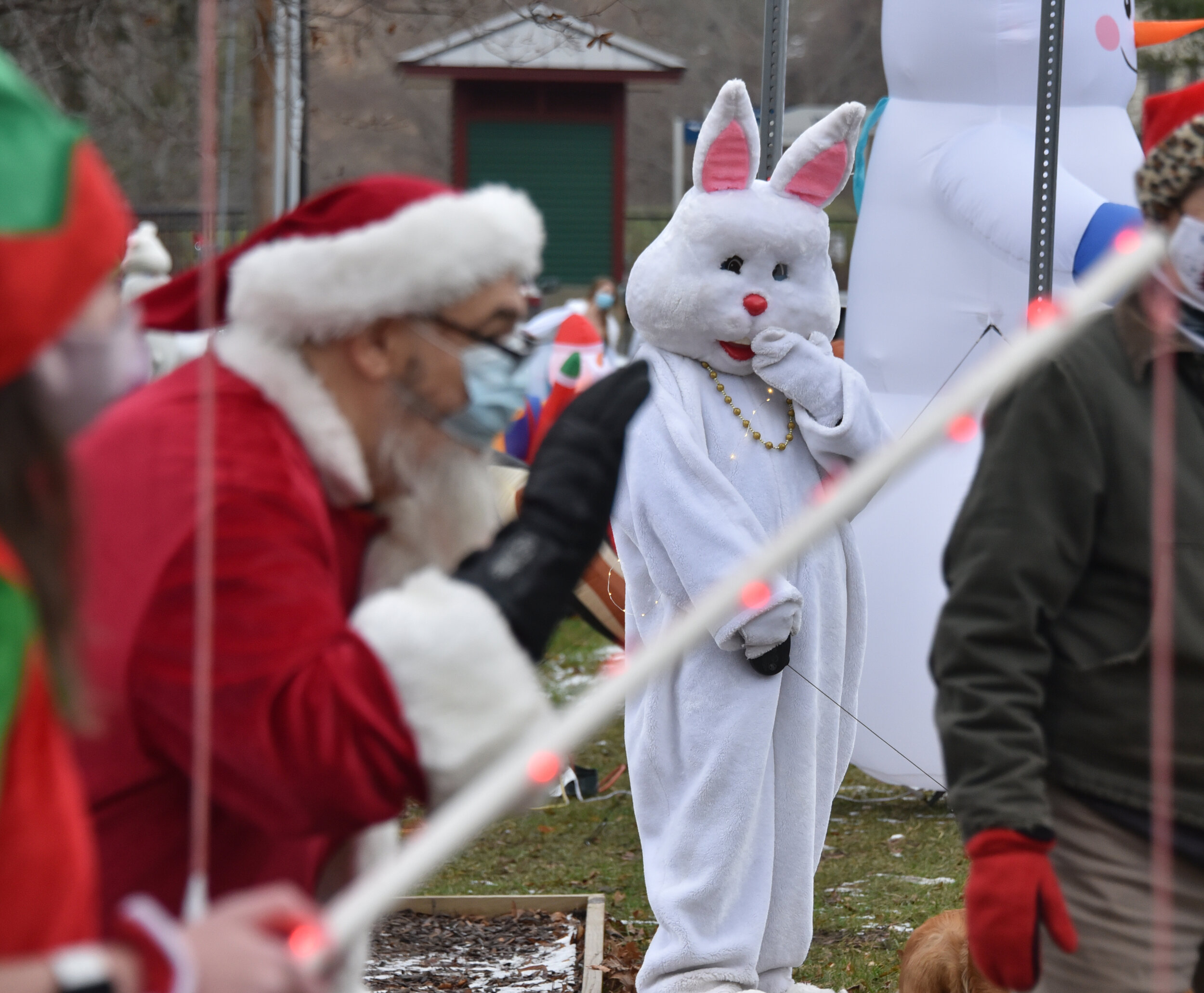  The Easter Bunny studies Santa's curbside appeal. Photo by Gordon Miller.  