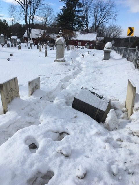 Tracks show where the vehicle just missed a row of historic gravestones but still toppled others. Photo by Jill Chase.