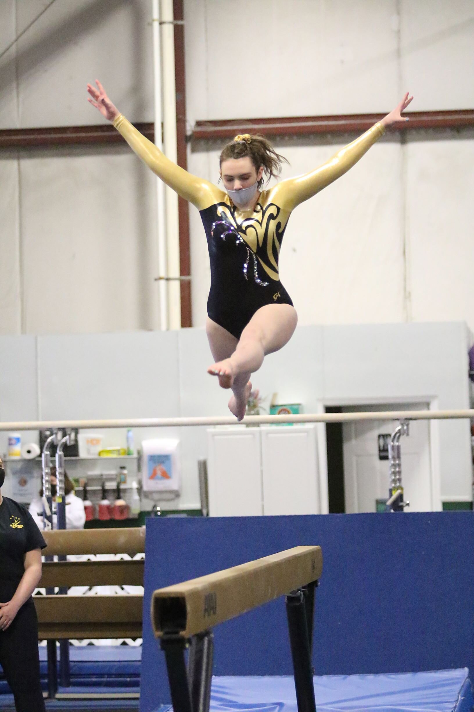 Senior Delana Cheney gets some air on beam. Photo by Paul Lamontagne/VtSportsImages.com
