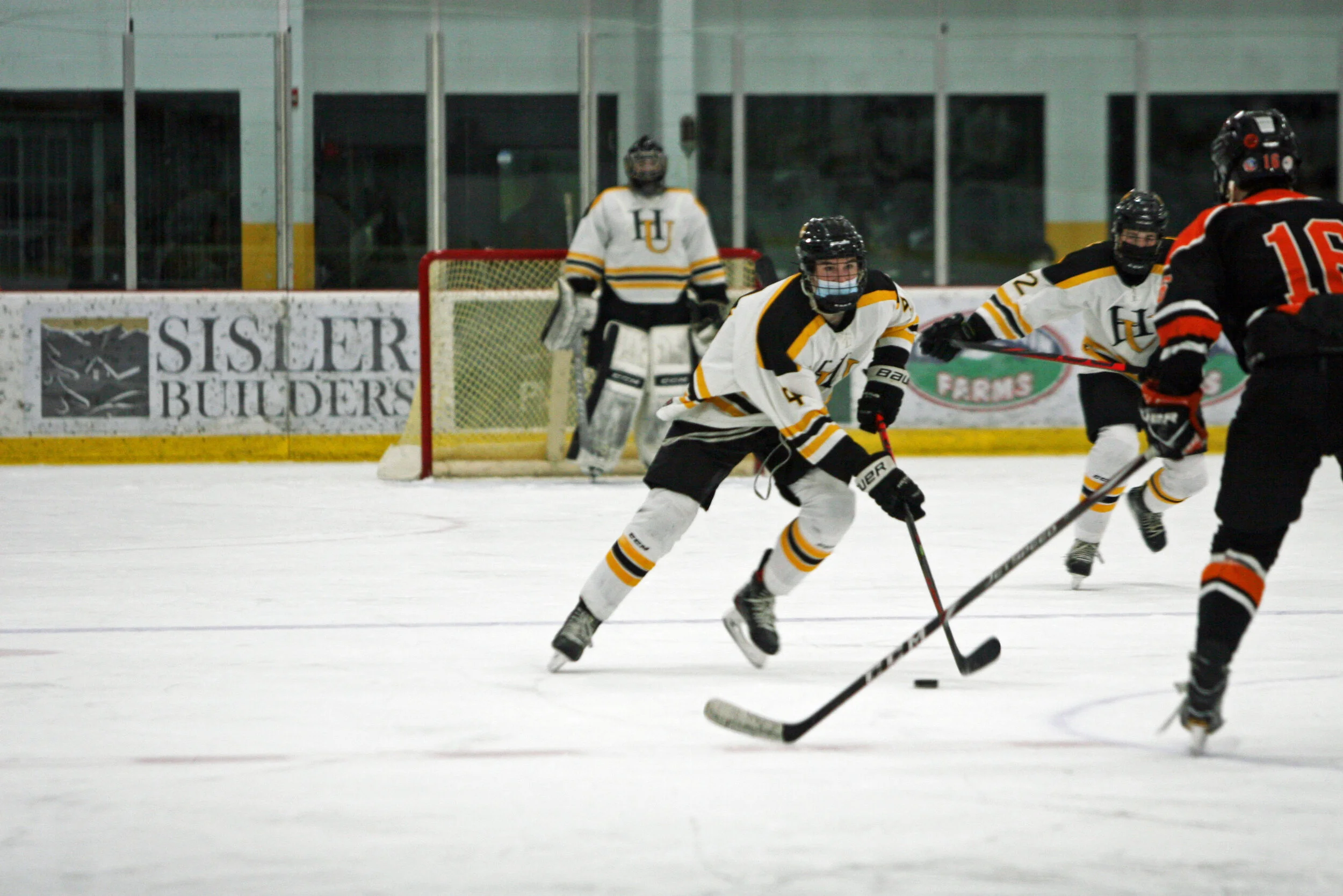  Jacob Green manages to keep an eye on the puck and the defense. Photo by Brian Larrabee 