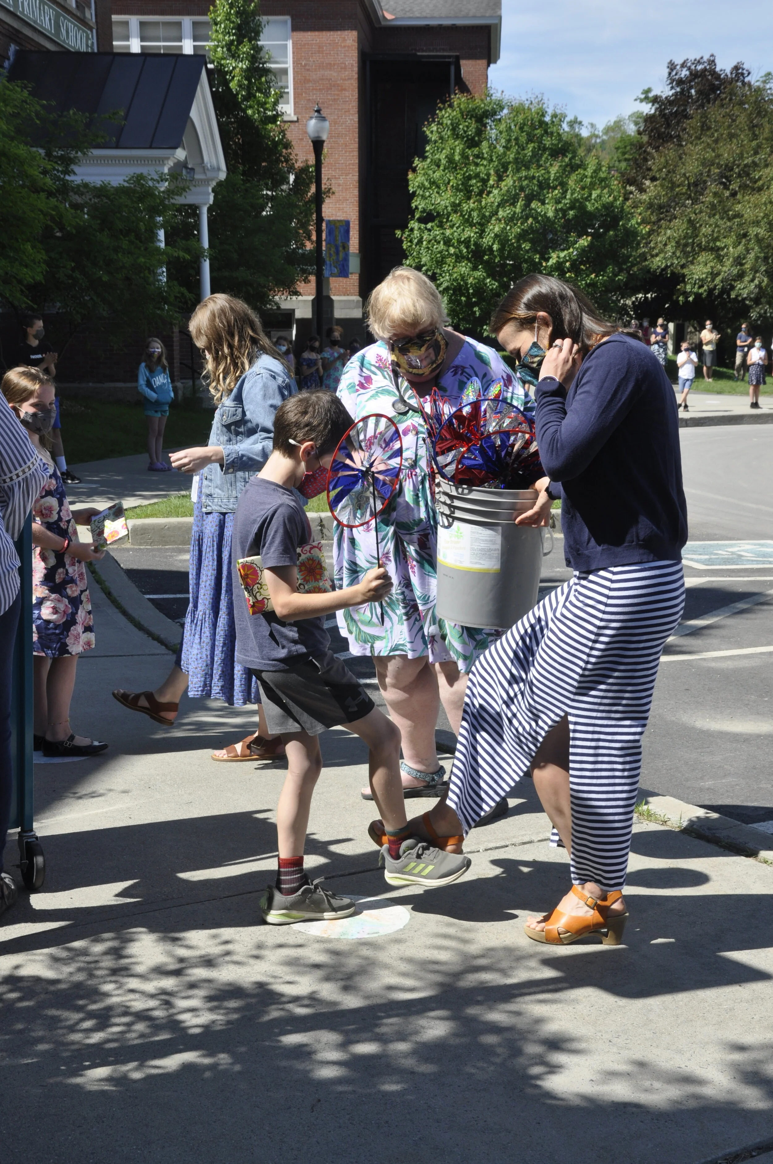  Teacher Camille Anderson does a foot bump with fourth grader Silvan Thompson as teacher Anne Hutchinson looks on. Photo by Lisa Scagliotti 