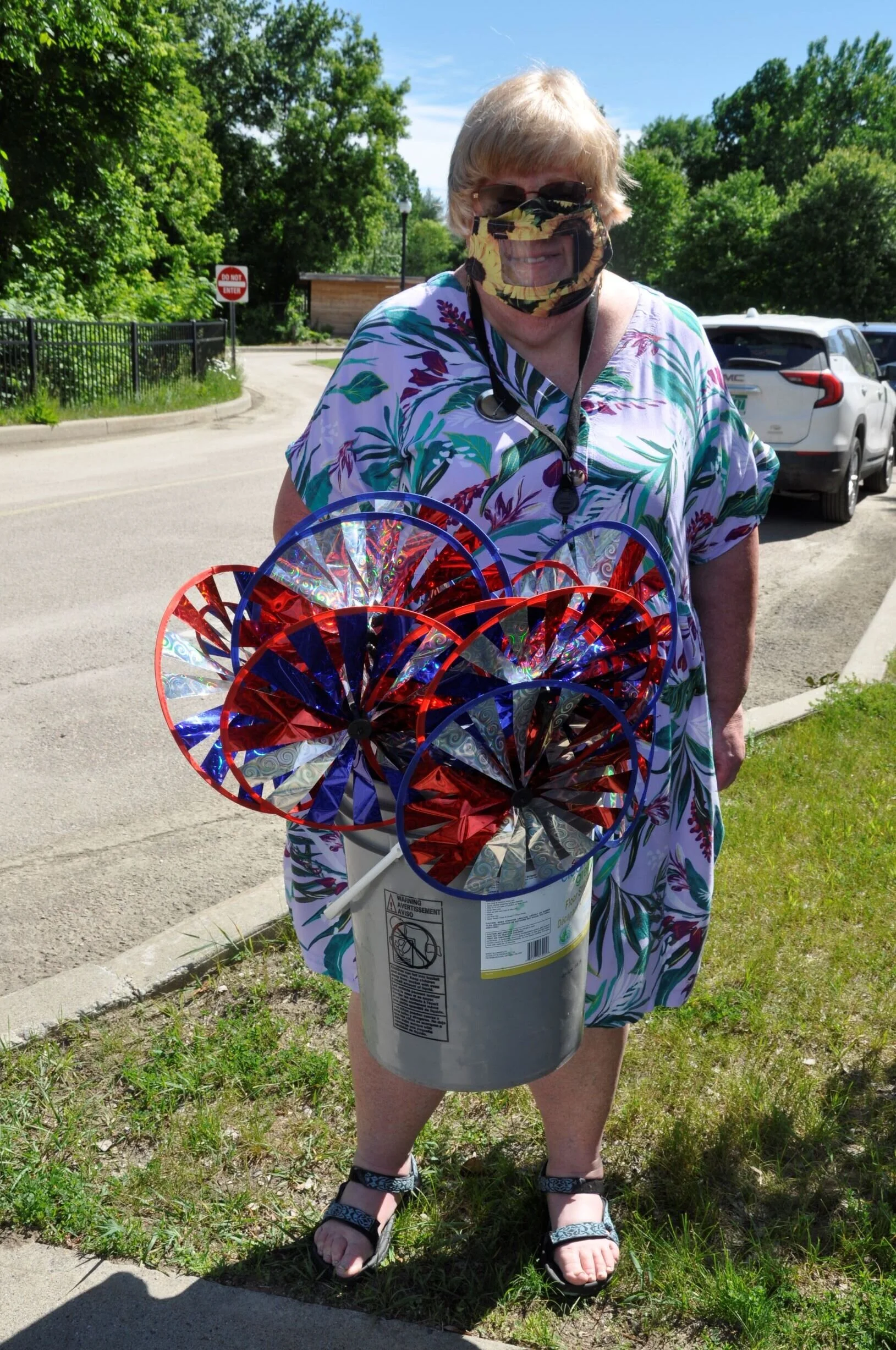  Teacher Anne Hutchinson models her transparent mask and the pinwheels she will give to her students.  Photo by Lisa Scagliotti 
