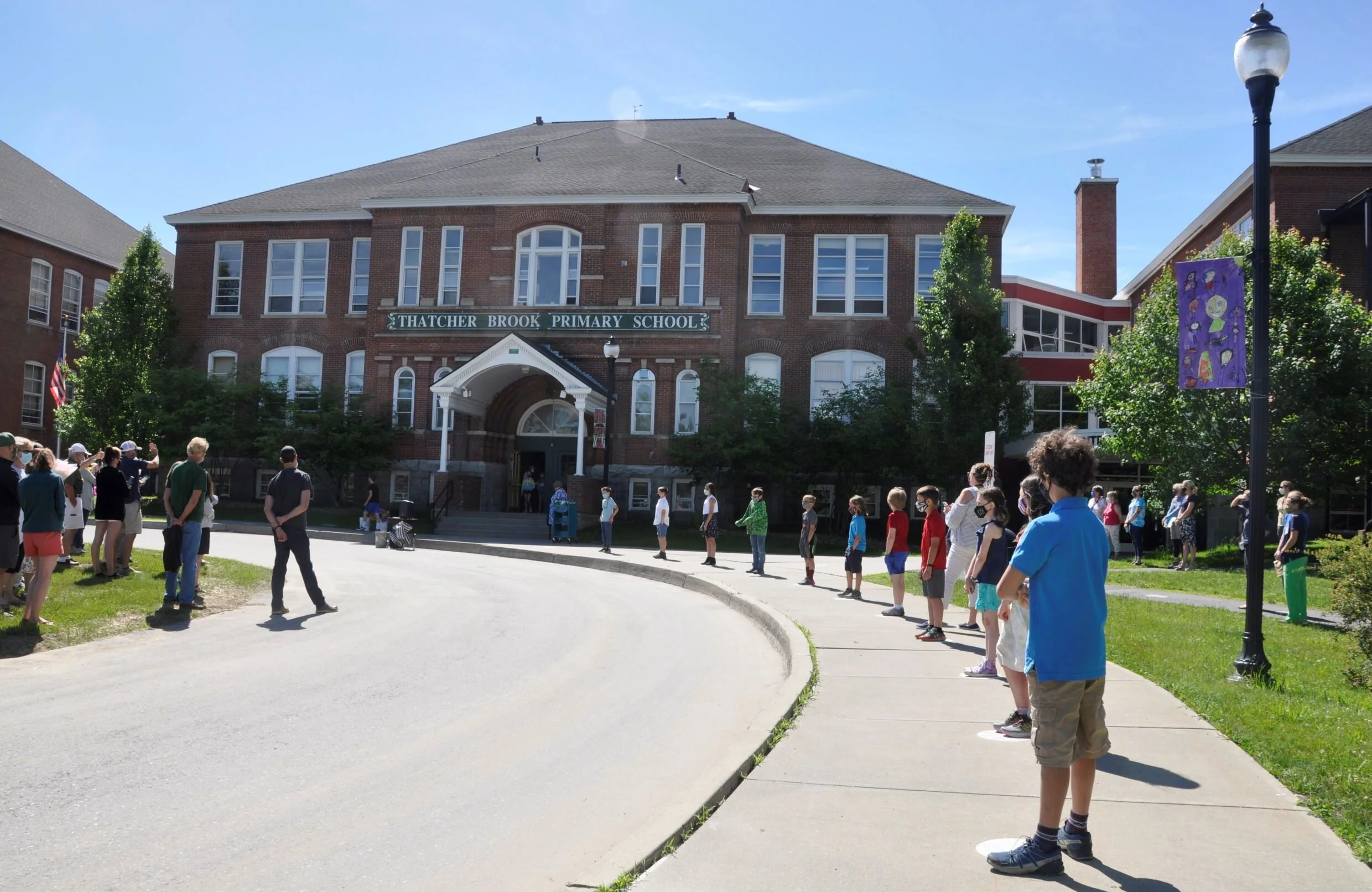  This year’s 4th grade sendoff was held outside with classes in two groups. Students lined the front walk and teachers visited with each one to present gifts and congratulations. Photo by Lisa Scagliotti 