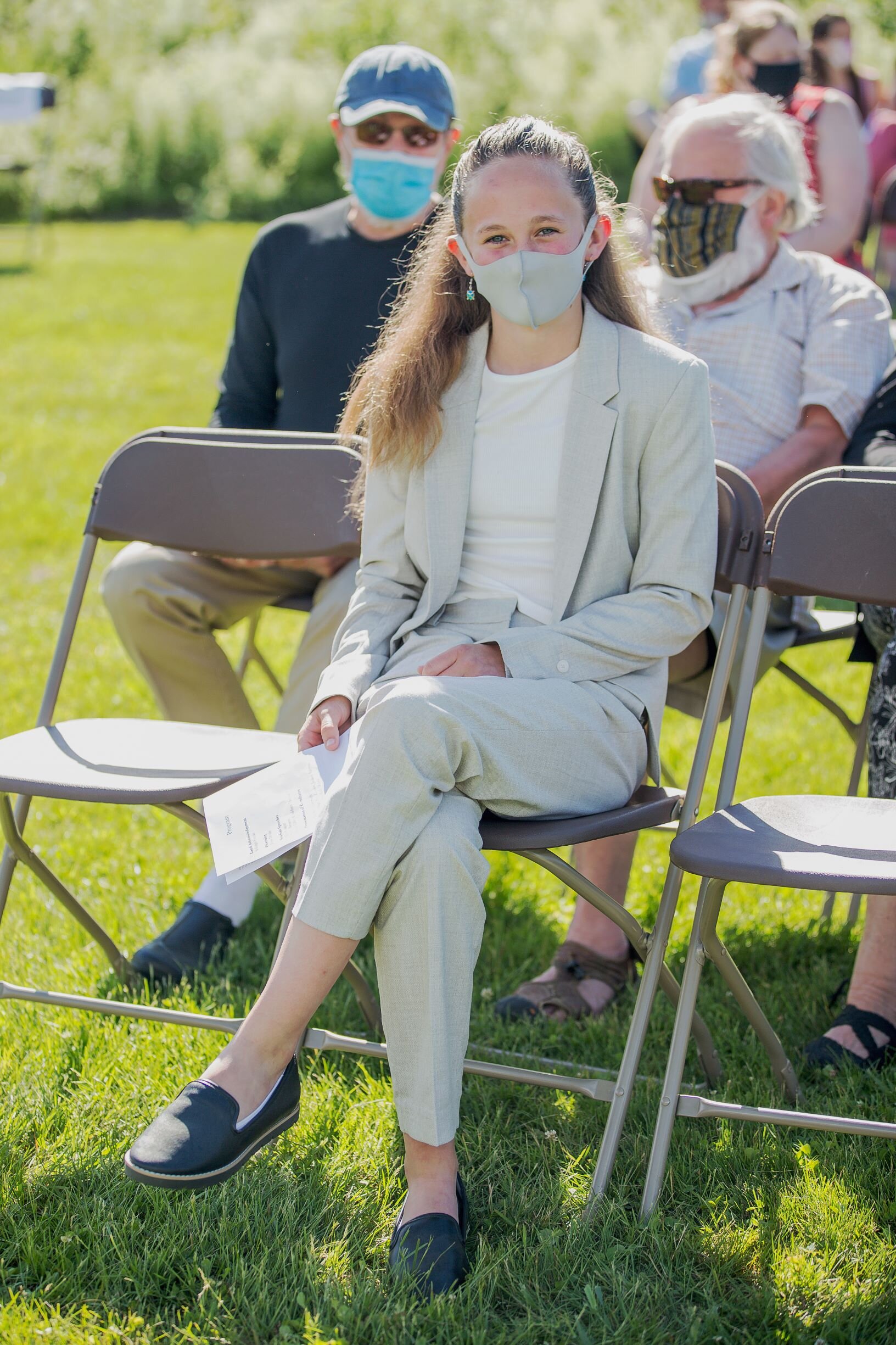   2020-21 taught everyone to recognize a smile behind a mask. Isabelle Fish awaits the ceremony. Photo by Michaela Milligan.  