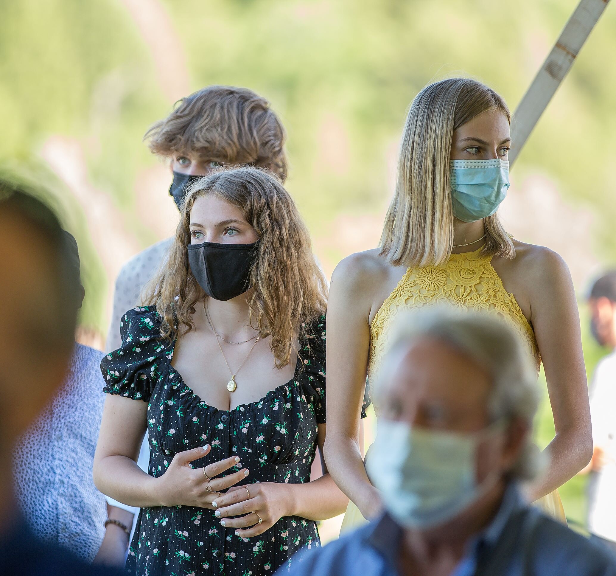 8th graders Thea Andersen (left), Olivia Ambler (right) and Evan Andrews (behind) stand at the front of the line ready to cross the stage to get their certificates. Photo by Michaela Milligan.