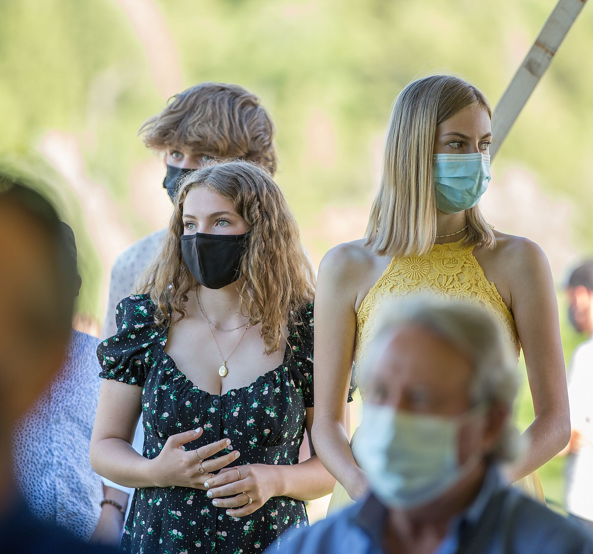   8th graders Thea Andersen (left), Olivia Ambler (right) and Evan Andrews (behind) stand at the front of the line ready to cross the stage to get their certificates. Photo by Michaela Milligan.  