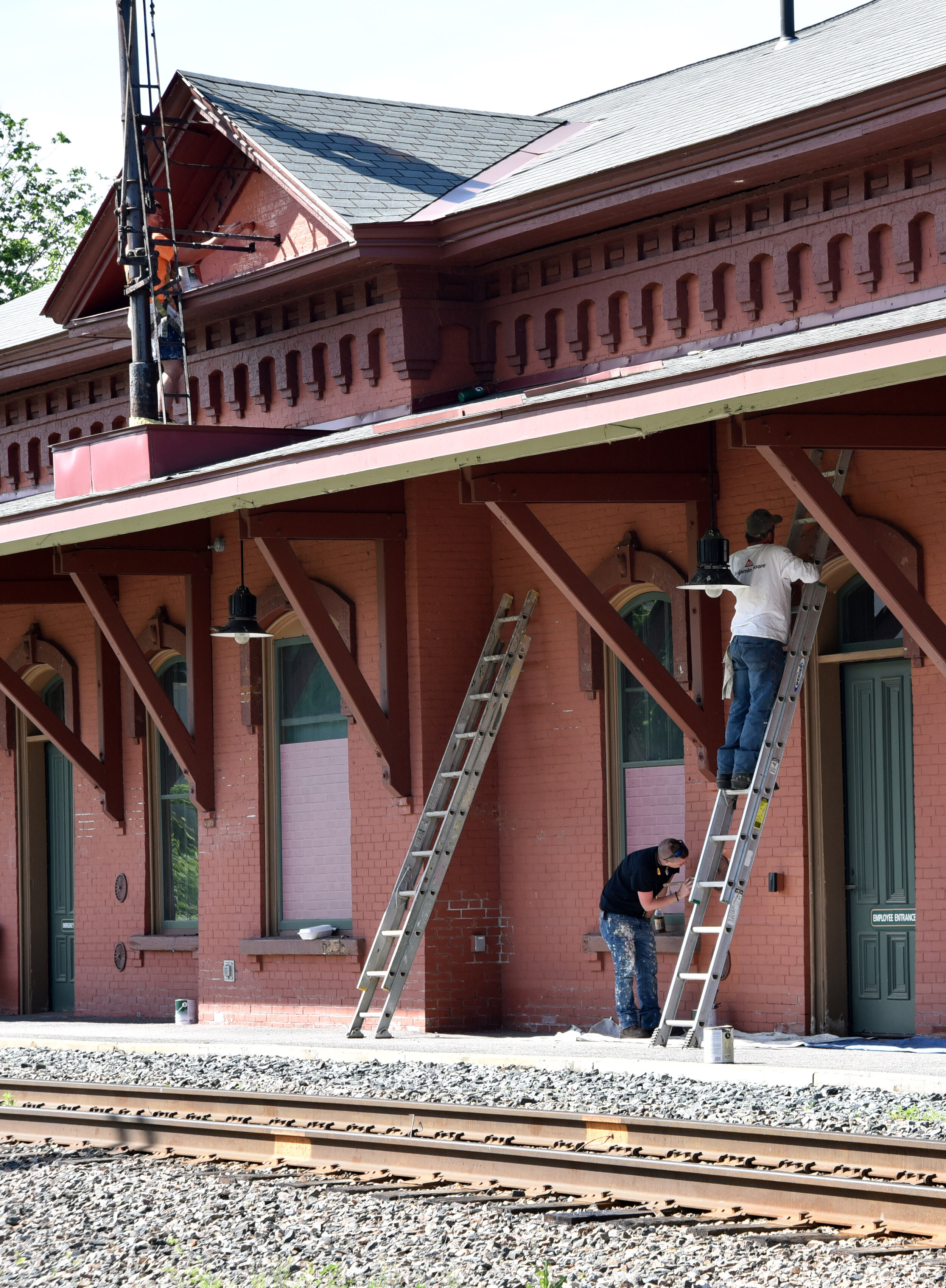   Workers from Russ/Wood Decorating in Richmond are repainting the entire exterior of the Waterbury Train Station. Photo by Gordon Miller.  