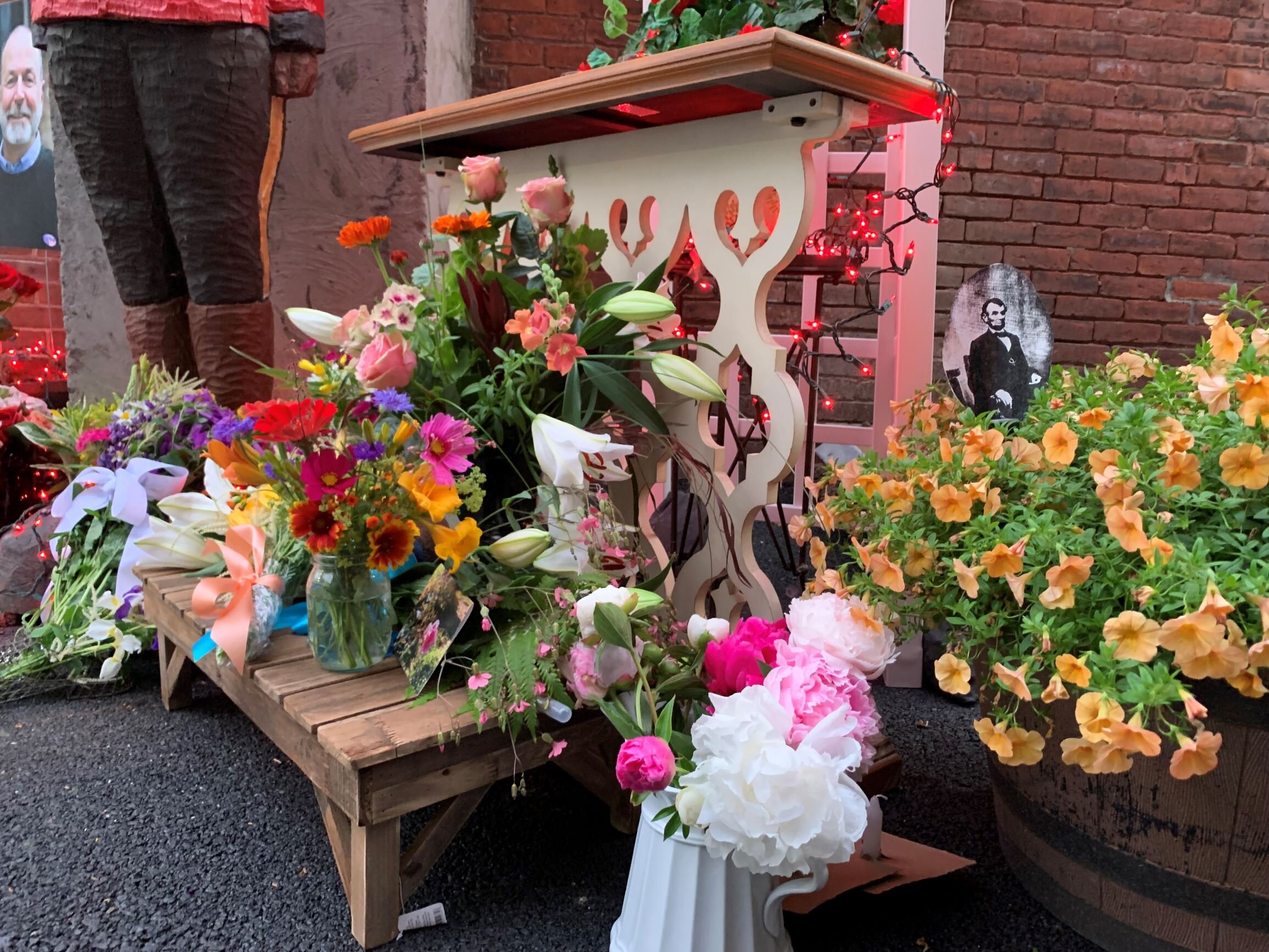   The quickly assembled memorial incudes flowers and mementos including a picture of President Abraham Lincoln in a nod to Jack Carter's love of Civil War history. Photo by Lisa Scagliotti.  