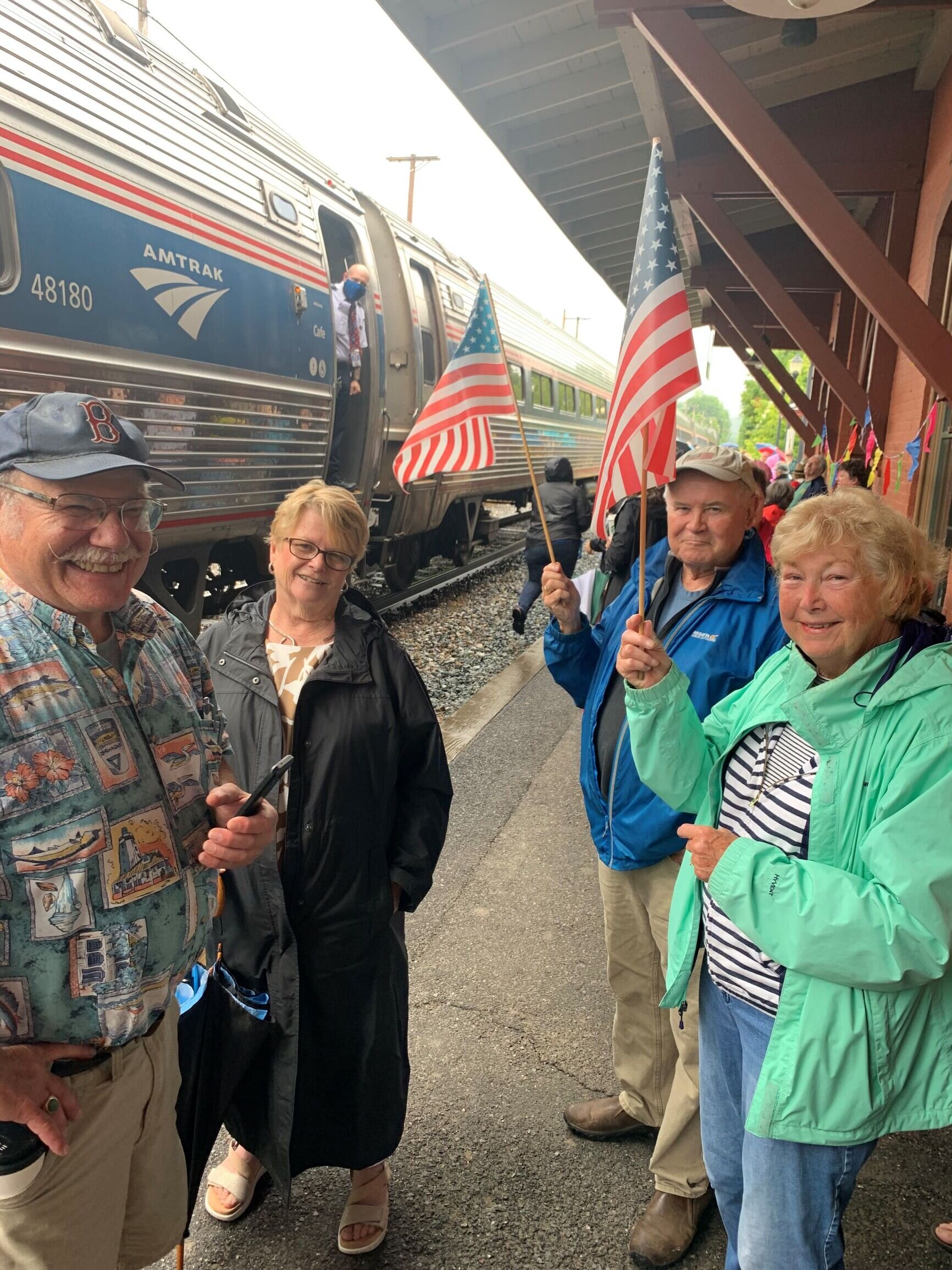   The arrival of Amtrak is a festive occasion. Left to right: John Malter, state Sen. Ann Cummings, David and Margaret Luce. Photo by Lisa Scagliotti  