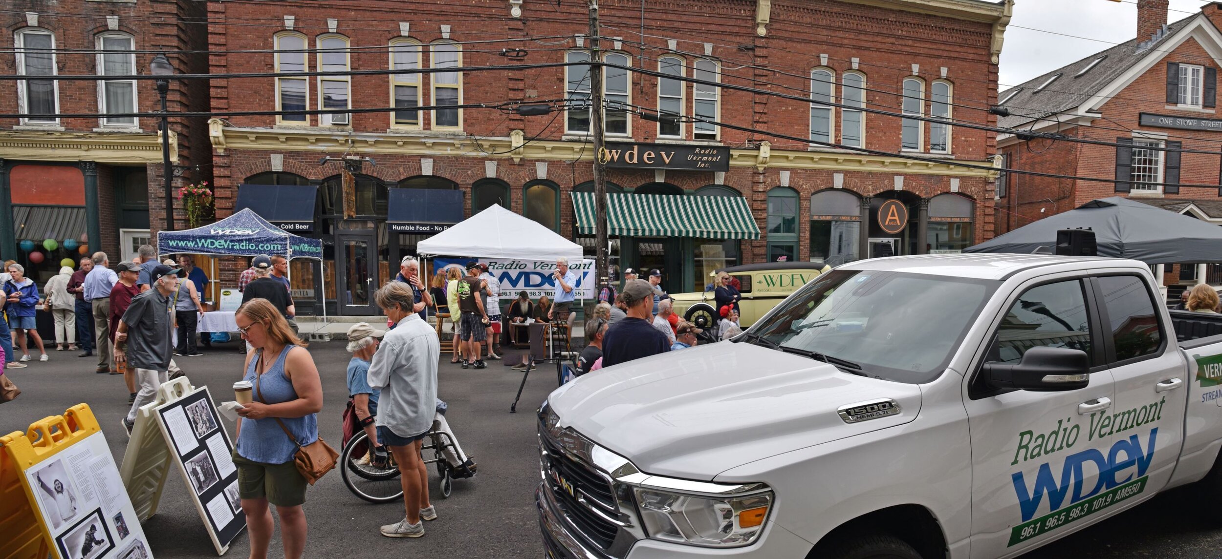   Lower Stowe Street is closed off for WDEV's 90th anniversary block party on Saturday, June 17. Audience members filled a seating area and milled about to check out exhibits with stories from the station's history along with free music CDs and video