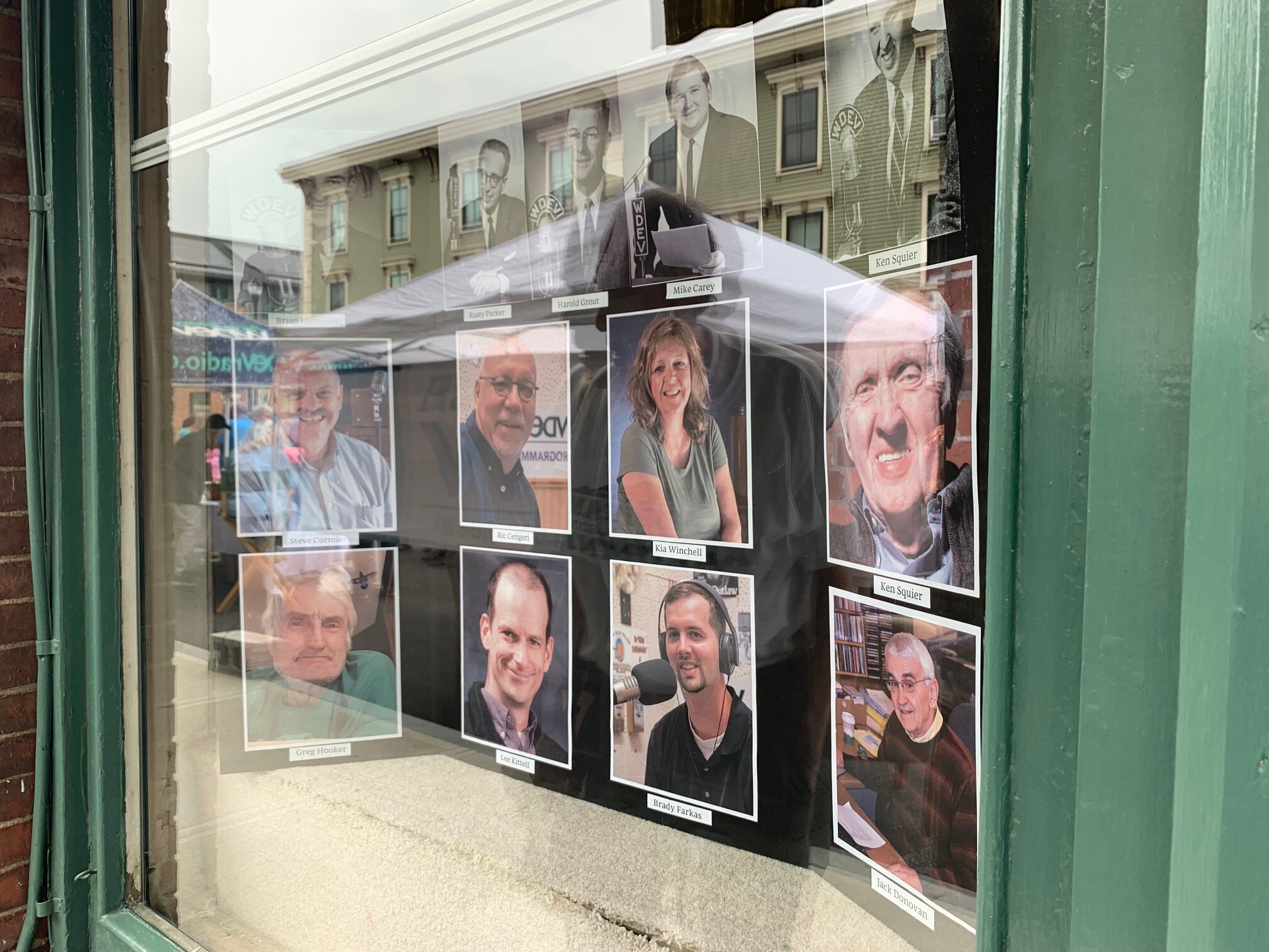   The WDEV storefront window tells its stories in portraits of past and present hosts. Photo by Lisa Scagliotti  