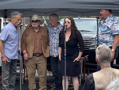   The musicians end the six-hour broadcast leading the audience in singing Happy Birthday. Left to right: Vermont folk singer Jon Gailmor, Rick Norcross, Dono Schabner, Taryn Noelle and Dave Rowell. Photo by Lisa Scagliotti  