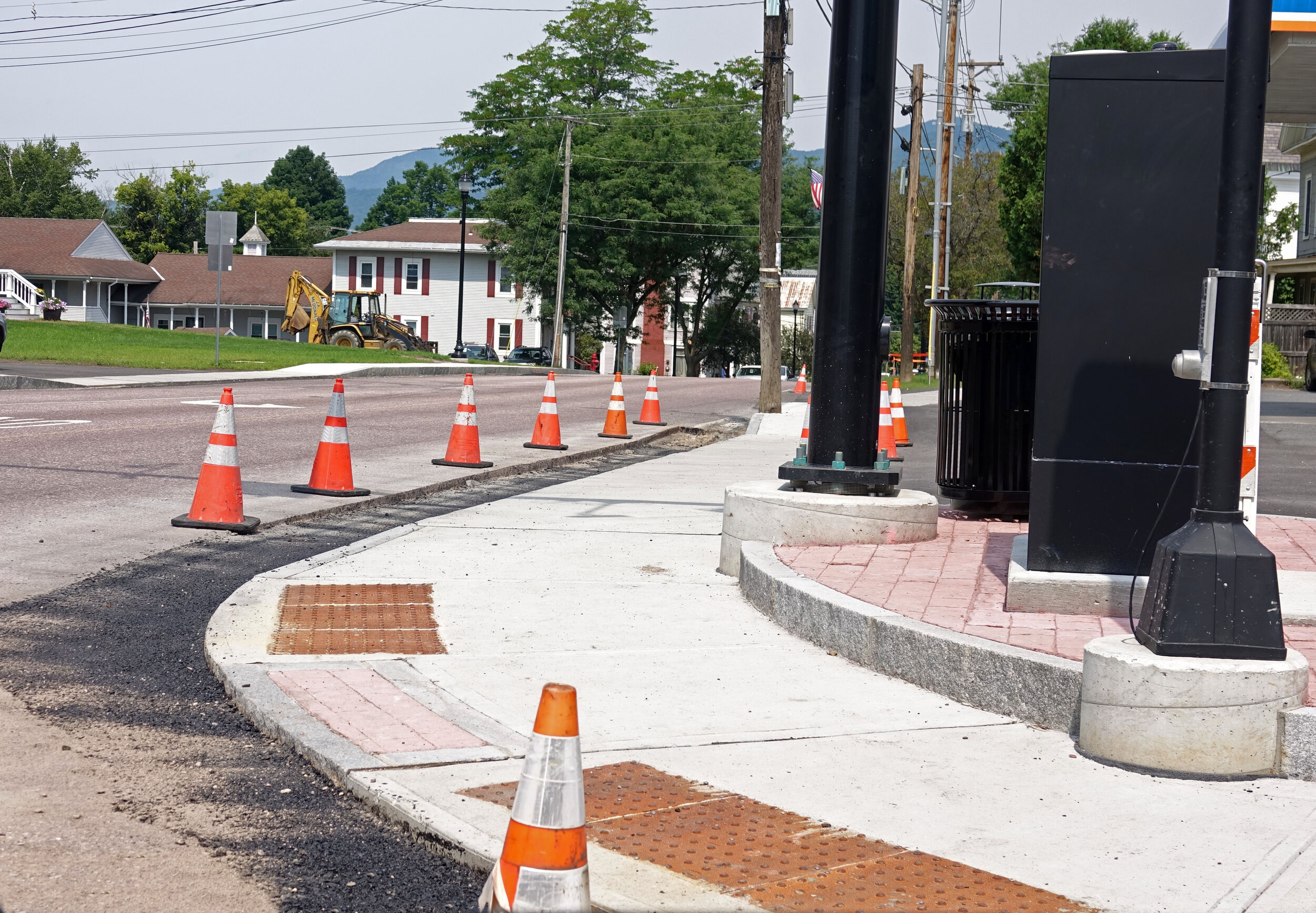   The sidewalk at the corner of Main and Stowe Street recently was completed with details to aid pedestrians. A new trash receptacle sits alongside the traffic signal post. Photo by Gordon Miller  