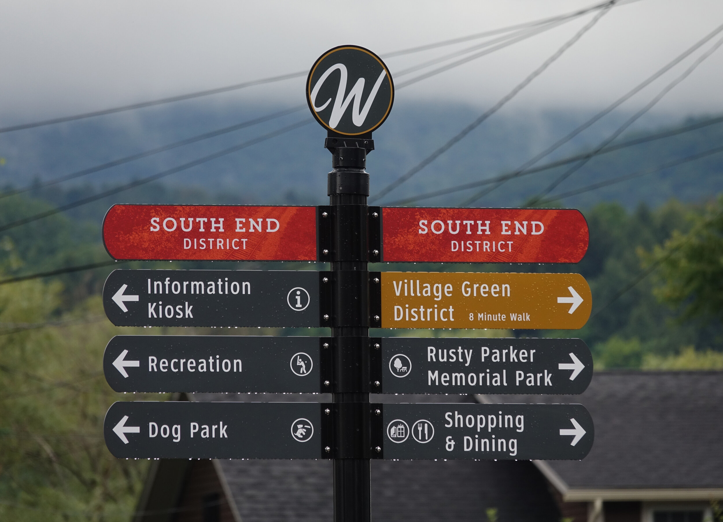   New wayfinding signs note sections of downtown, parks, and activities like shopping and dining. The markers on South Main Street post will correspond with a nearby kiosk. Photo by Gordon Miller  
