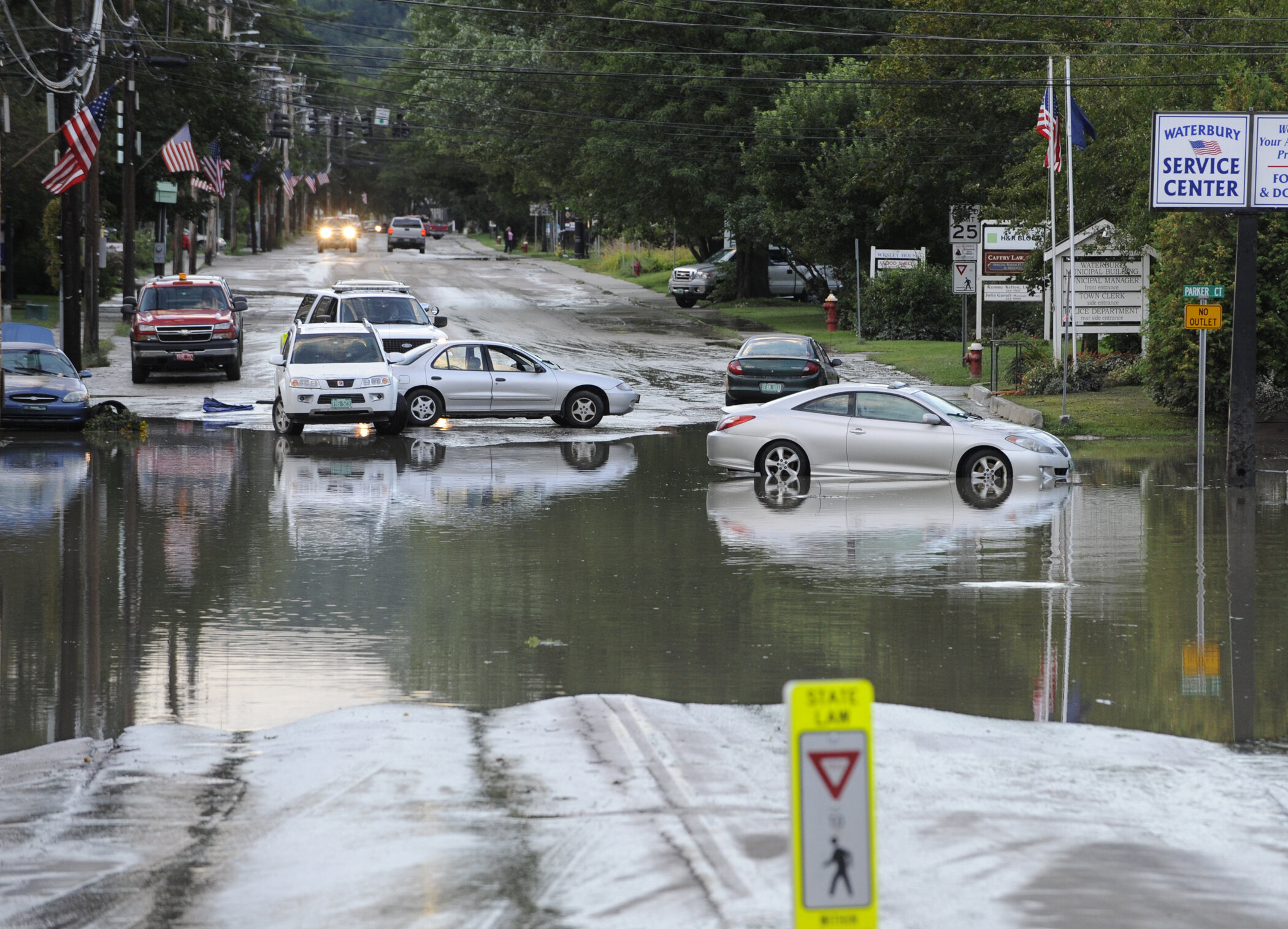  People try to navigate Main Street as the water recedes. Photo by Gordon Miller 