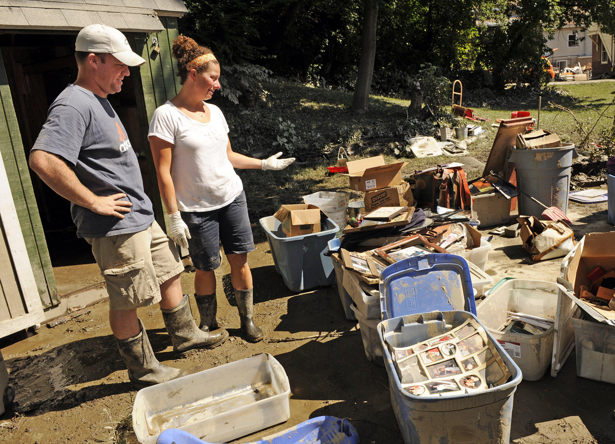  Cory and Kelley Hackett survey possessions from their home and home child care on Elm Street. Photo by Gordon Miller 