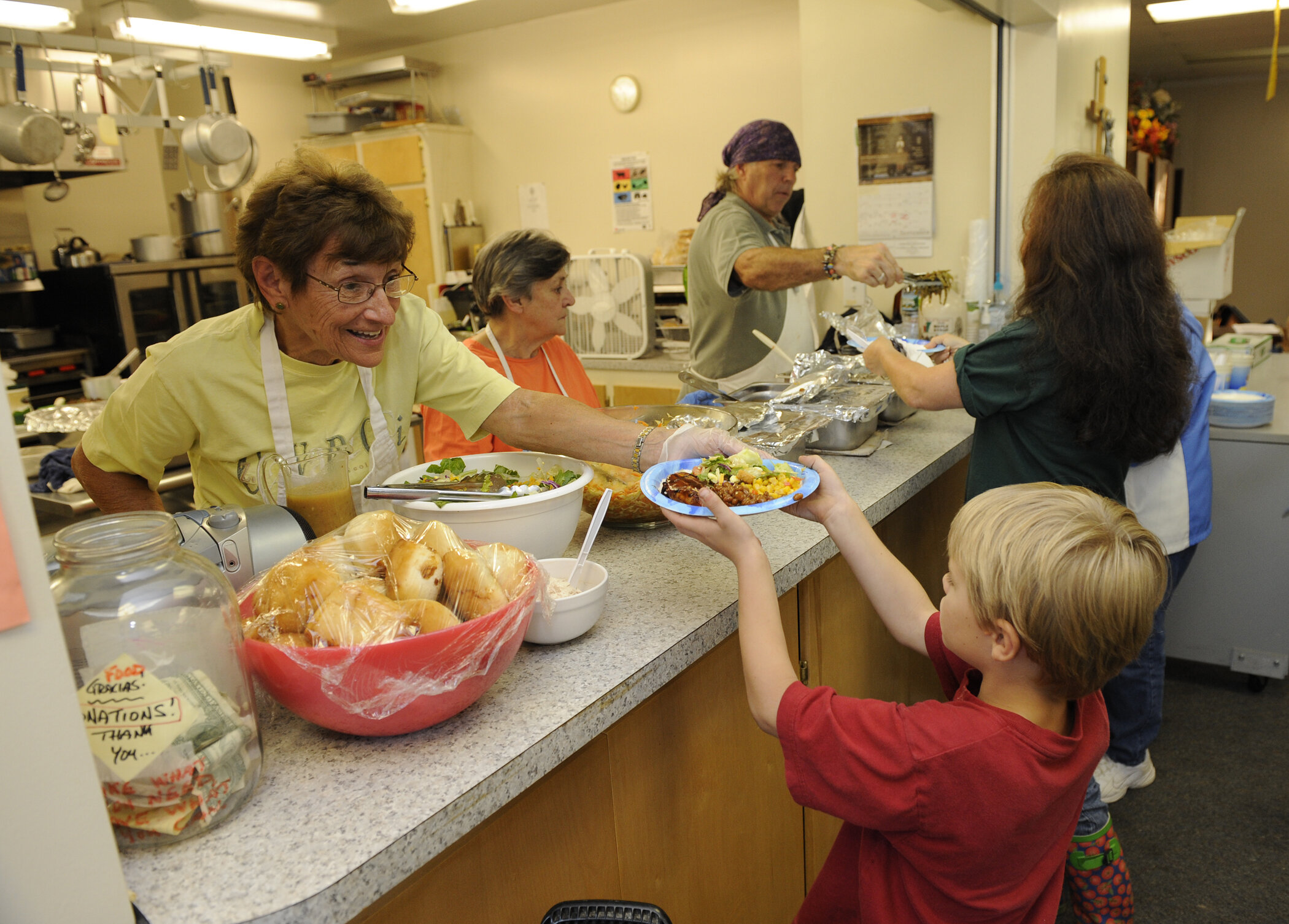  Mary Miller serves meals at St. Leo’s Hall. Photo by Gordon Miller 