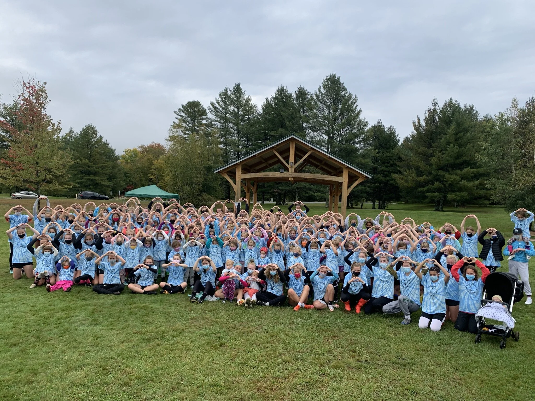   The group does a heart salute to Mary. Photo by Lisa Scagliotti  