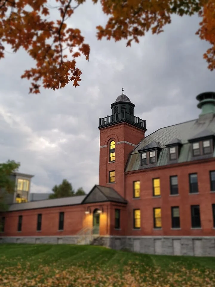   Golden leaves still on branches and on the ground frame this glimpse of part of the old State Complex. Photo by Becky Blackman  