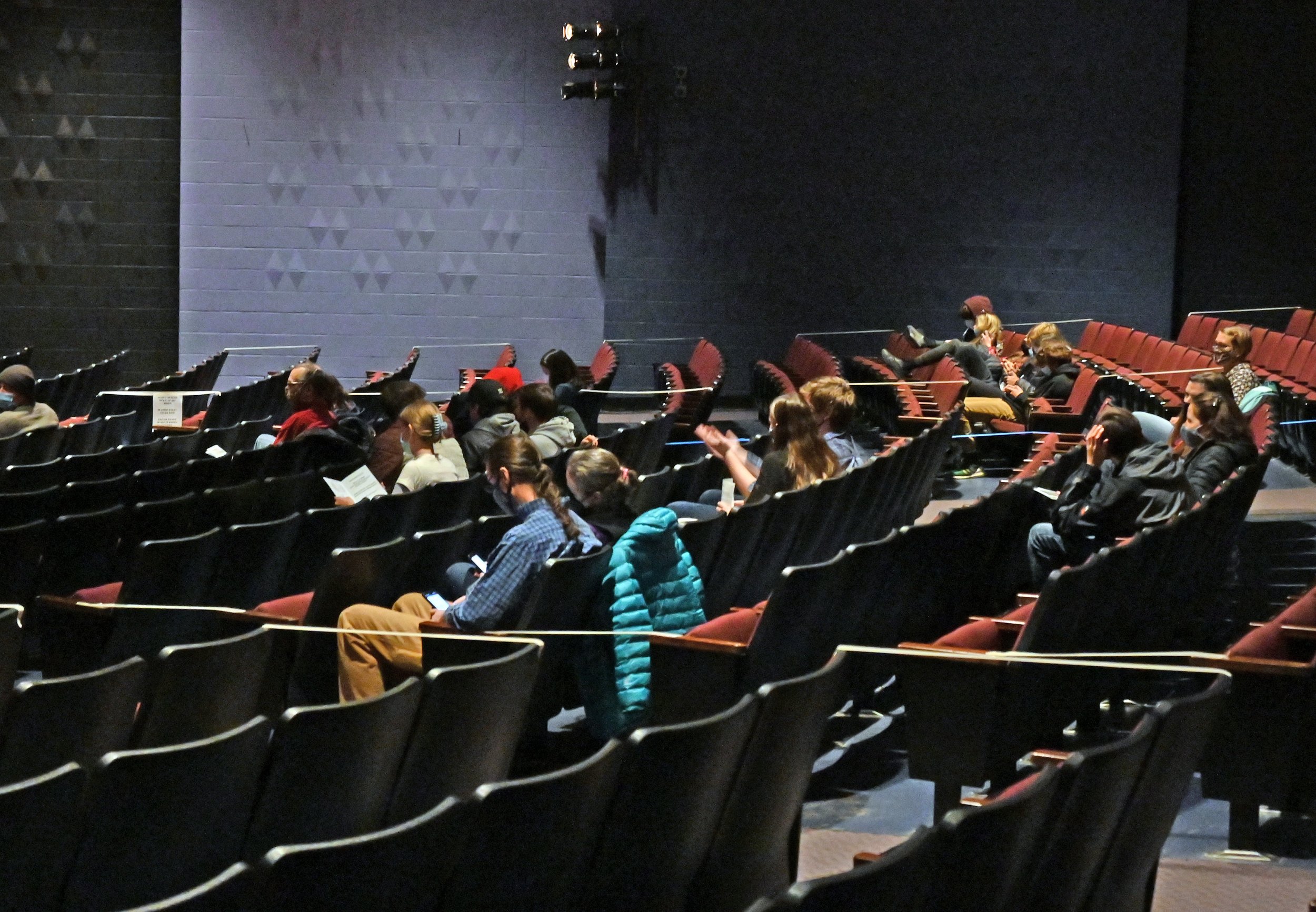   Masked audience members sit distanced with every other row cordoned off in the auditorium. Photo by Gordon Miller  
