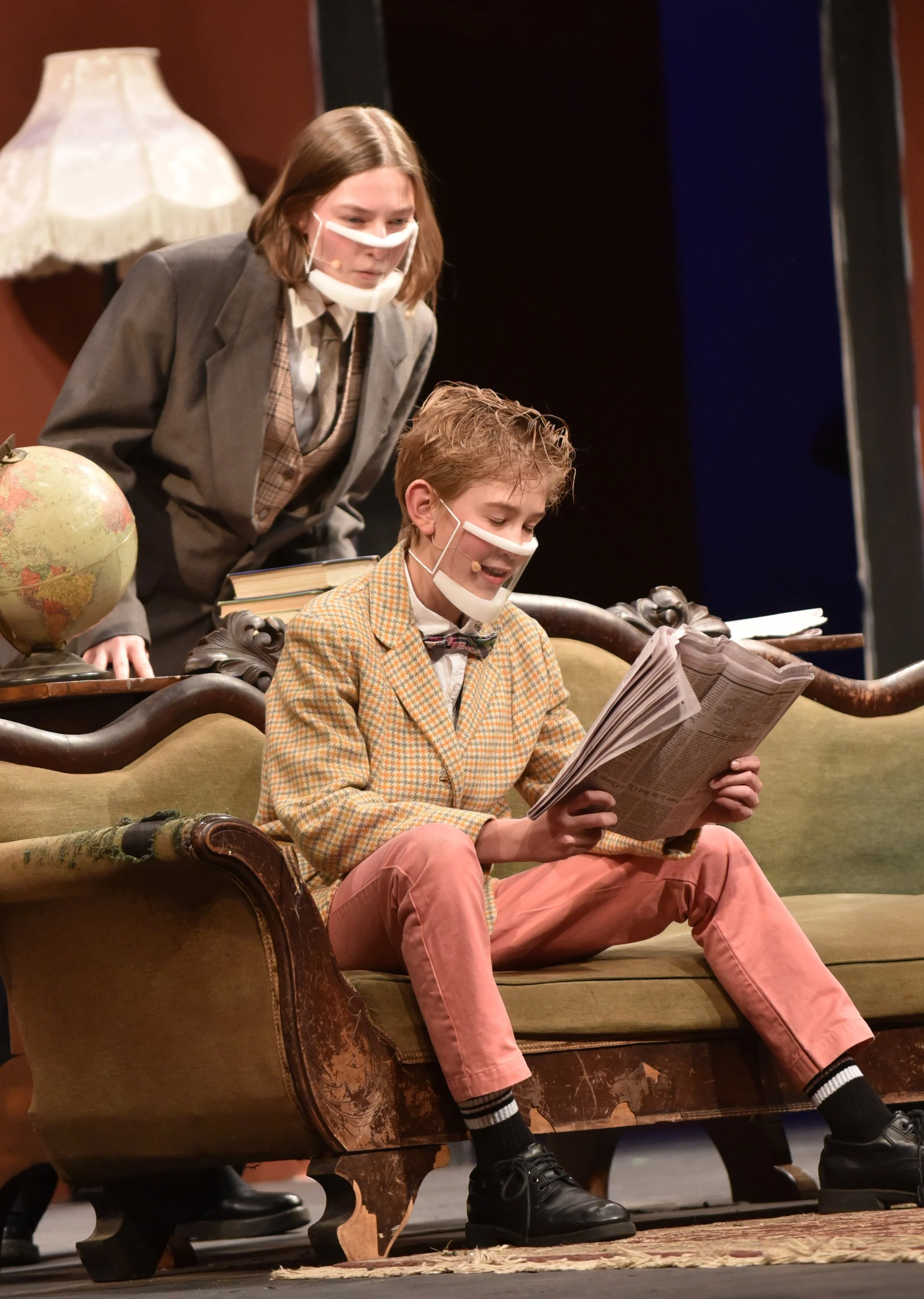   Newspaper accounts of a murder set the scene for the two-act play. Arianna Clark as Giles Ralston looks over the shoulder of Tarin Askew playing Christopher Wren. Photo by Gordon Miller  
