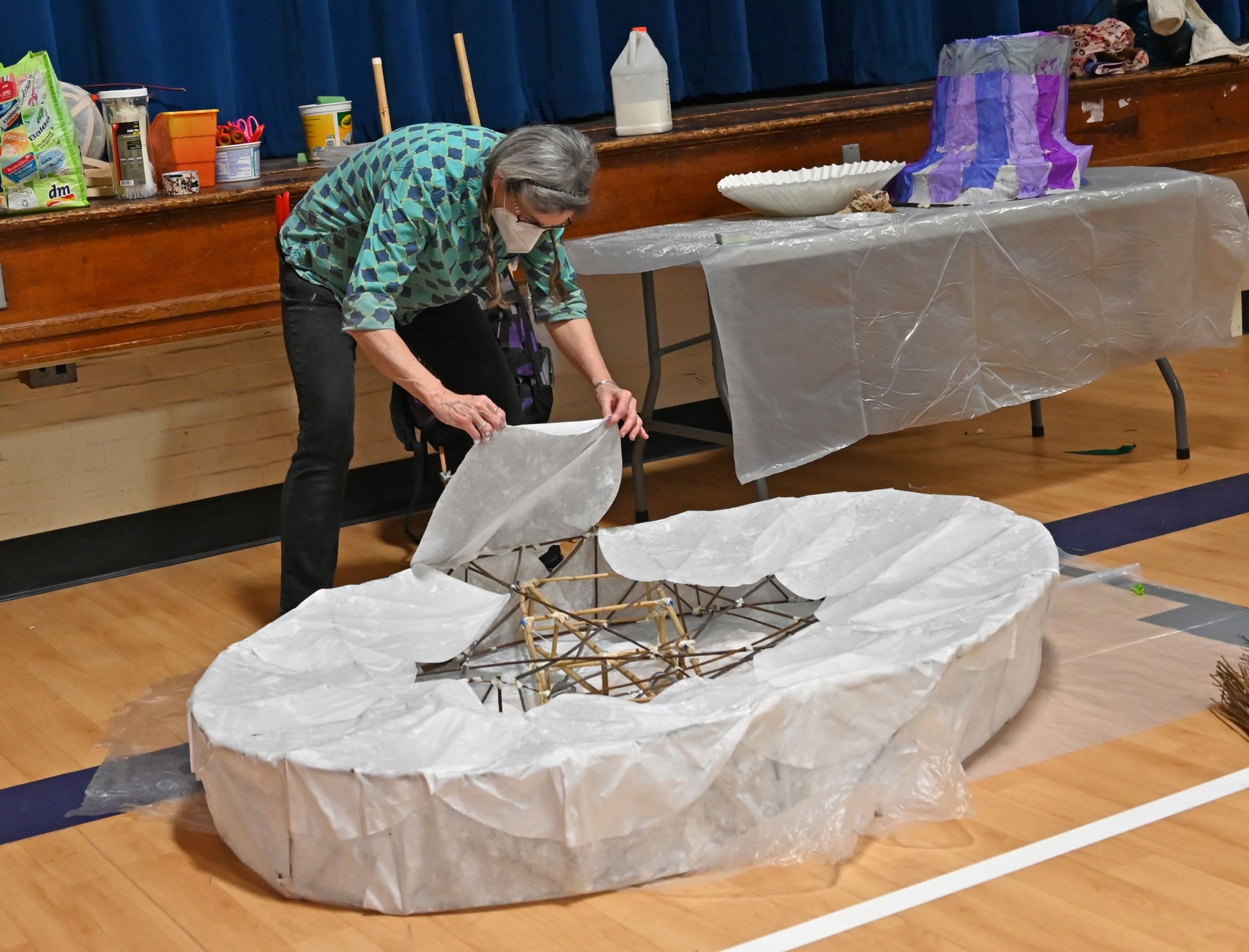  Mame McKee carefully works on a large artist palette lantern. Photo by Gordon Miller 