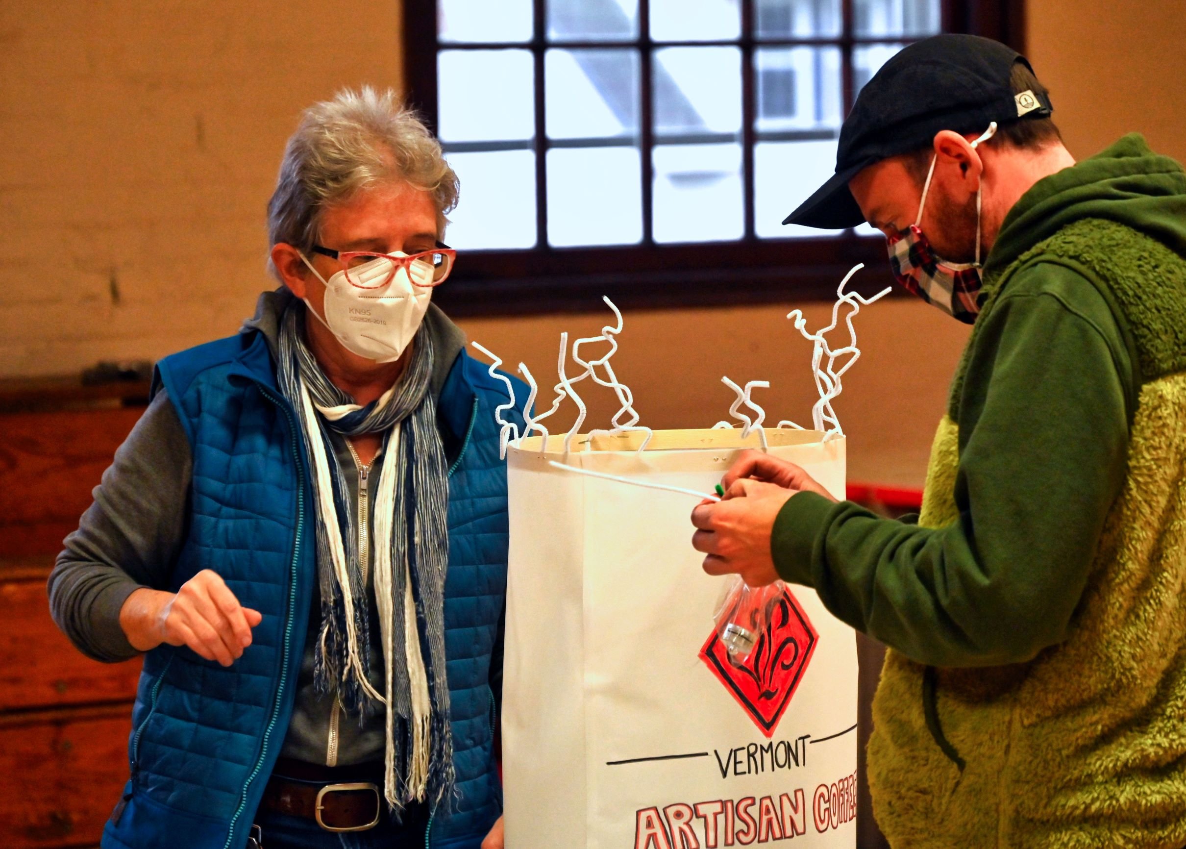  MK Monkley (left) gives Noah Derman a hand on his lantern that salutes Vermont Artisan Coffee and Tea. Photo by Gordon Miller 