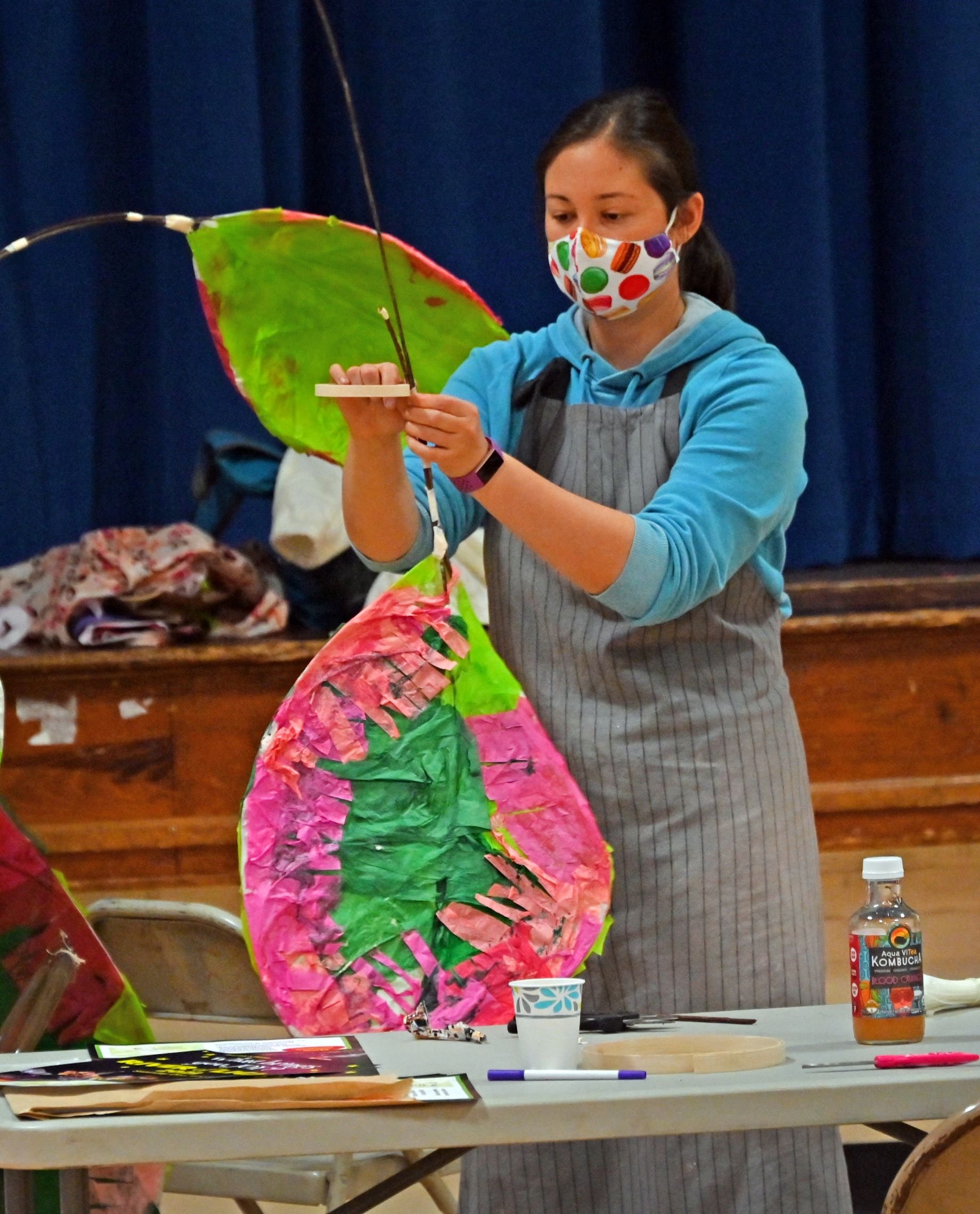  Community members create lanterns that will stand out among the smaller ones made by the primary school students. Chiyomi McKibbin's rubber plant lantern is especially colorful. Photo by Gordon Miller 