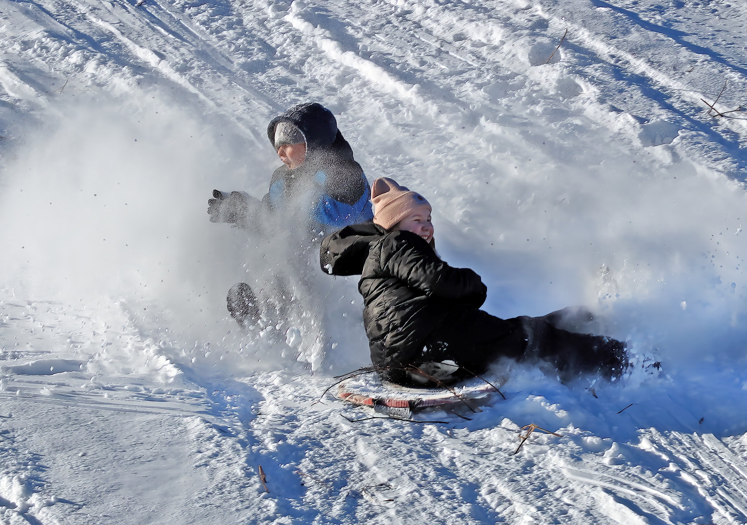  Gracie and Blake Barber get a snowy downhill thrill. Photo by Gordon Miller 