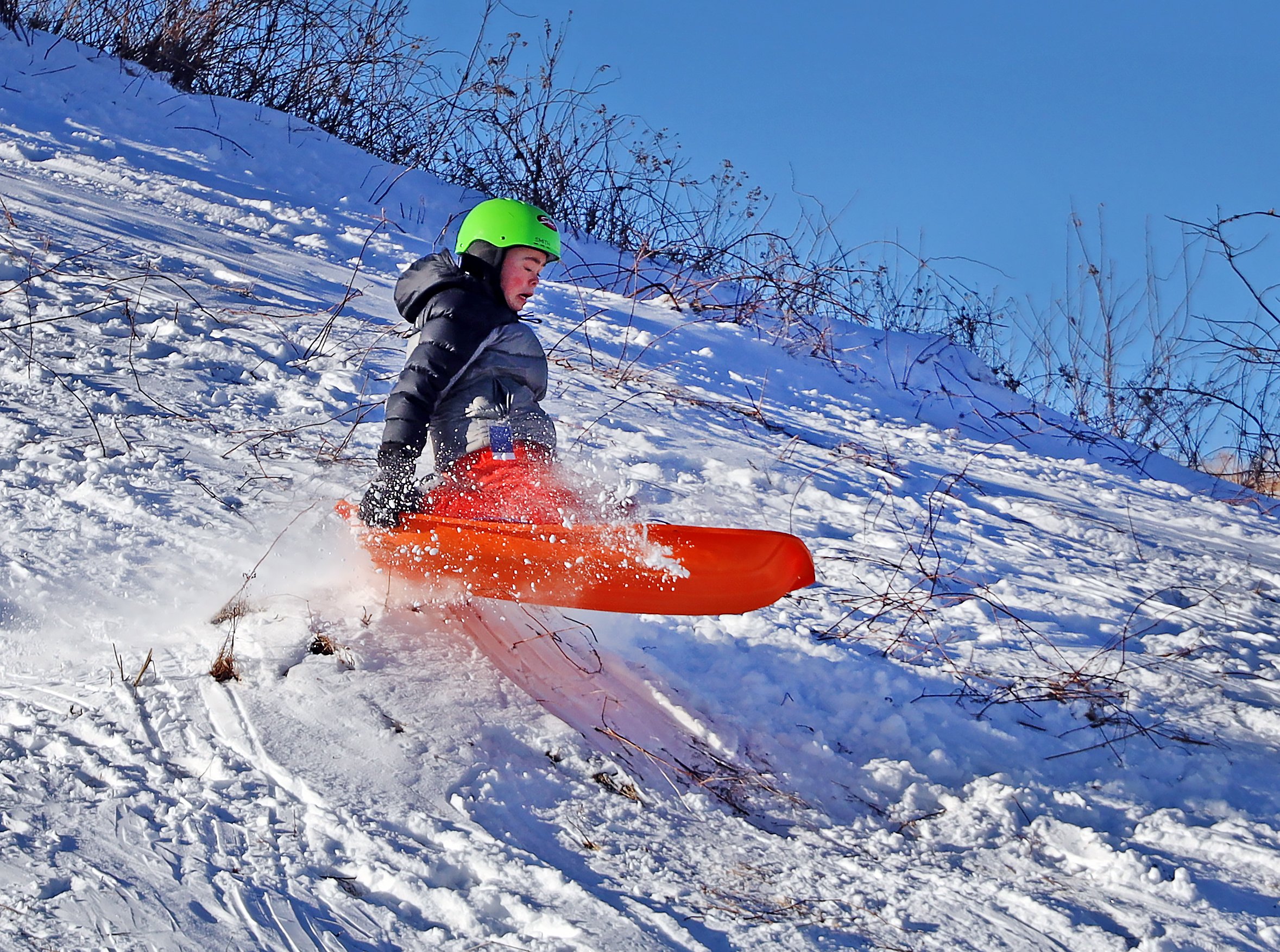  Greason Eley catches some air on the sledding hill at Crossett Brook Middle School on a perfect January Saturday. Photo by Gordon Miller 