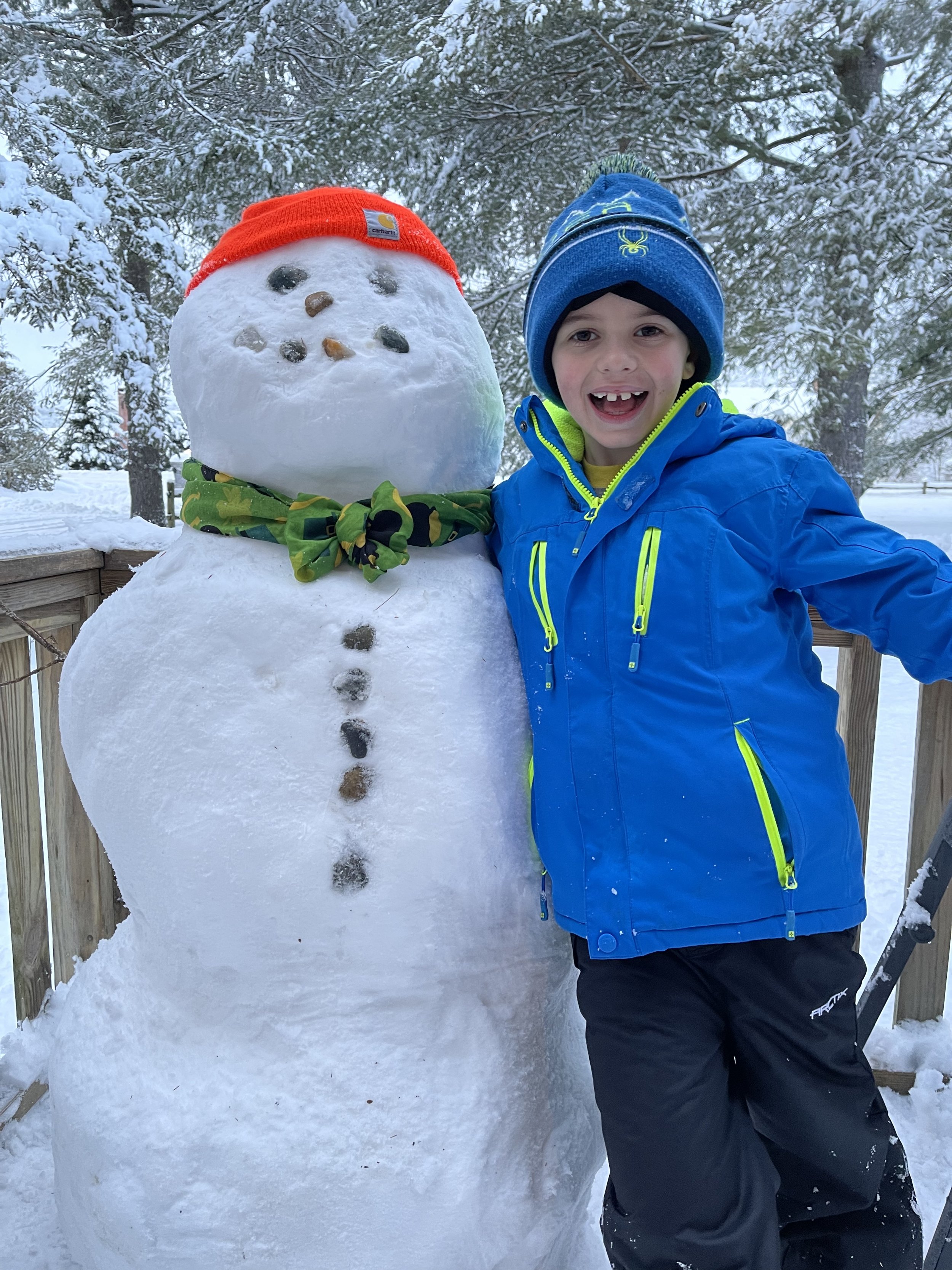   Why shovel the porch when you could build a snowman on it instead? Jaxon in Stowe chose the latter. Photo by Nikki Kennedy  