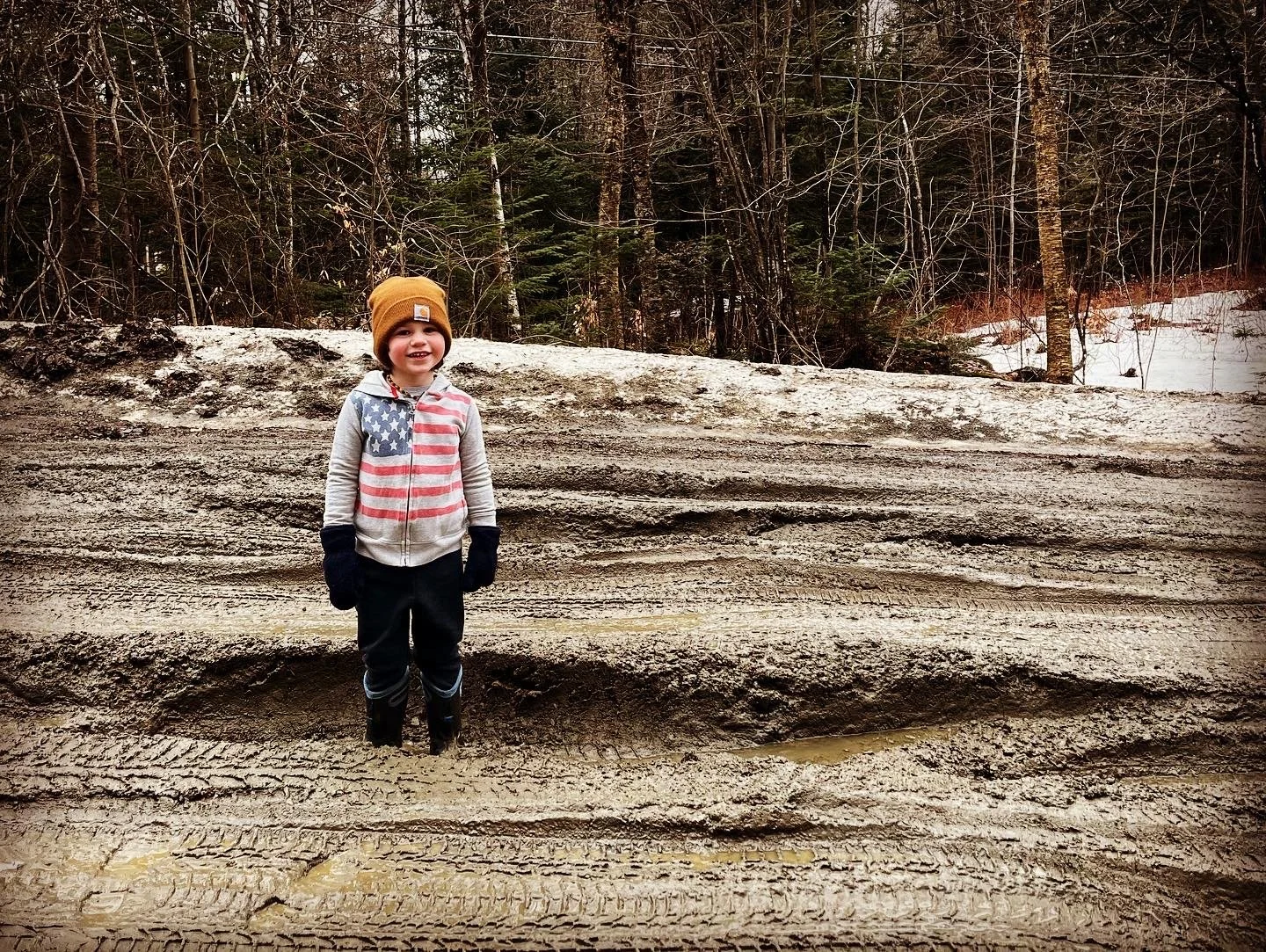  “This quicksand is TOTALLY deep!”  declares Nolan Bouchard in shin-deep mud on Crossett Hill Road in Duxbury. Photo by Alyssa Mullan 
