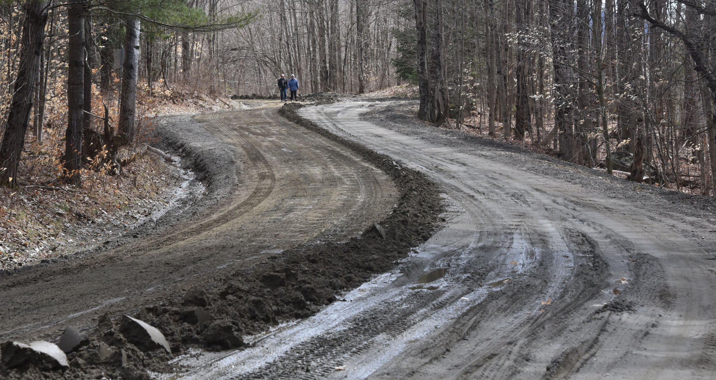  Walkers navigate the mud and freshly graded swath along Valley View Road. Photo by Gordon Miller 