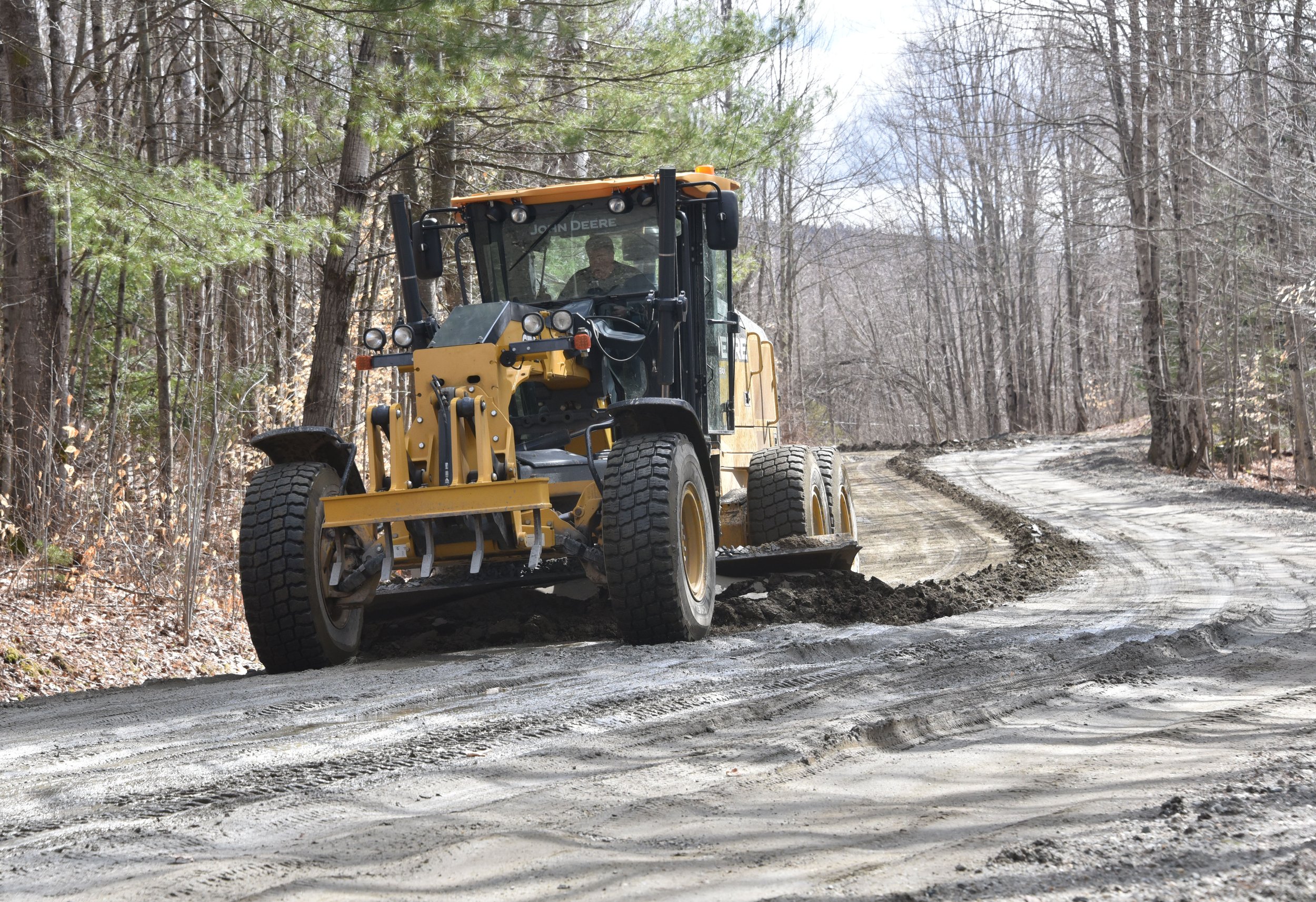  Help is on the way. Grading is under way as town road crews work to scrape and fill ruts and return roads to passable condition. This grader works on Valley View Road. Photo by Gordon Miller 