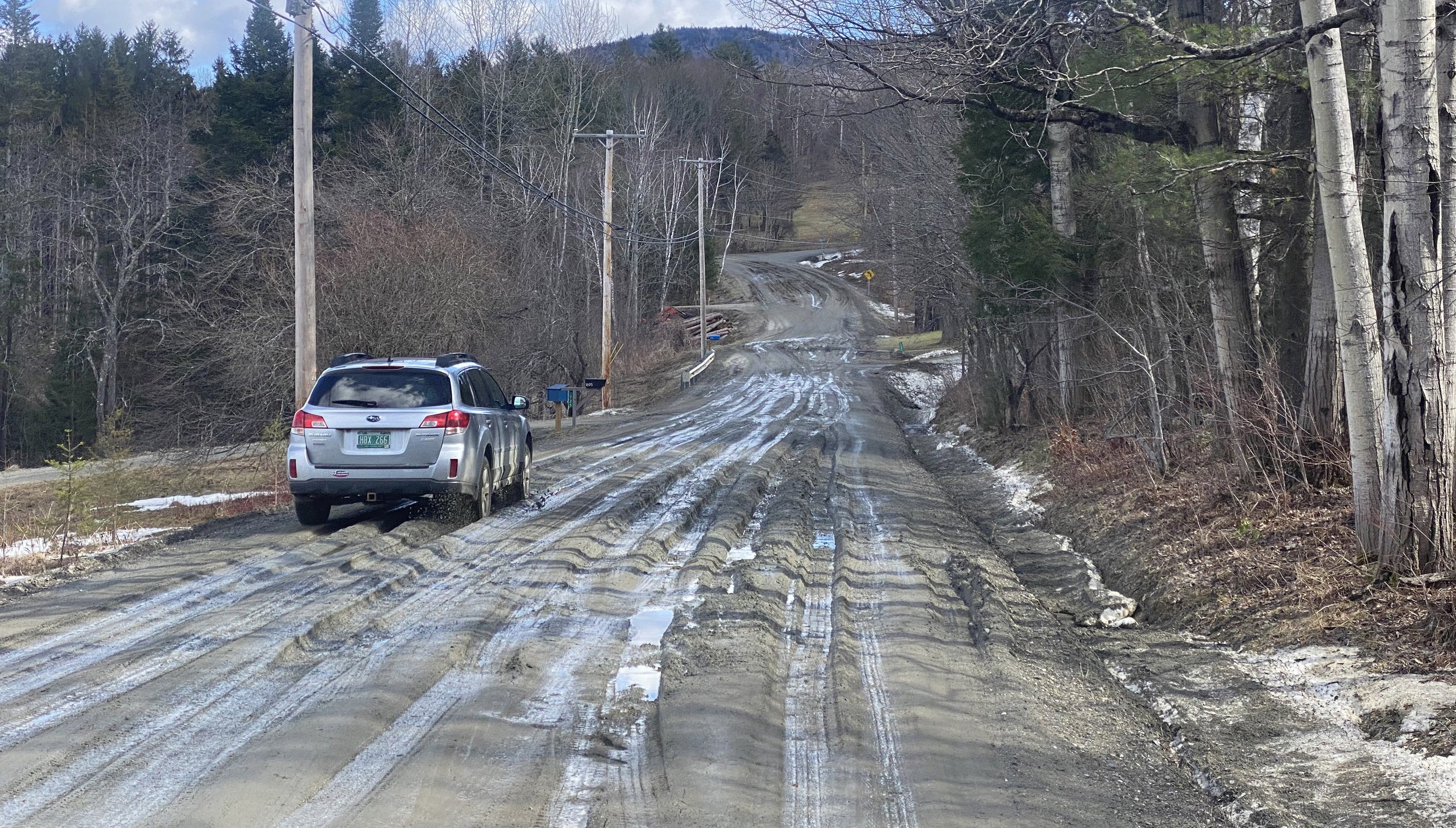  Sometimes you need to use the other side of the road. A Subaru navigates the ruts on Perry Hill on Monday. Photo by Gordon Miller 