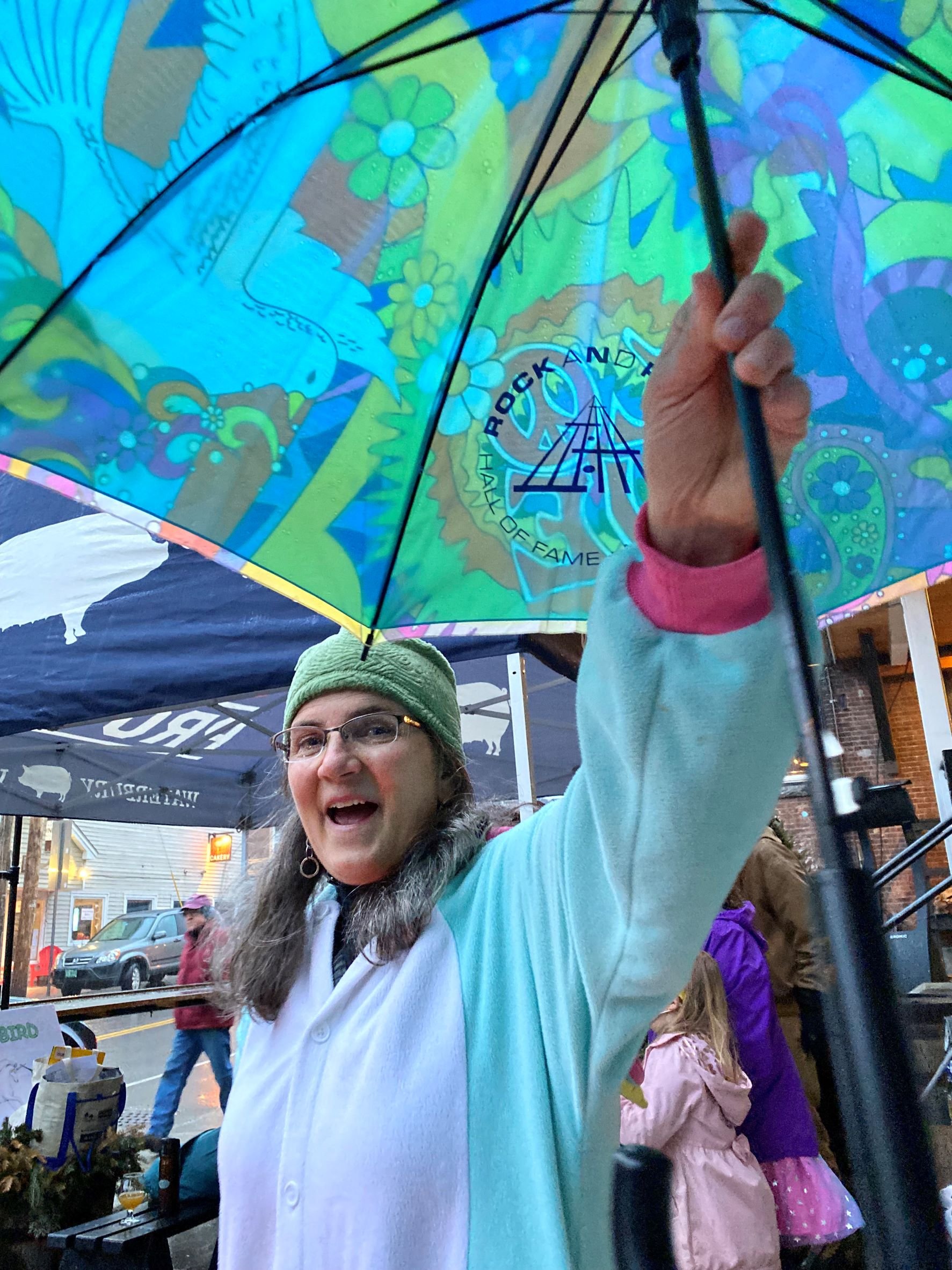 Wassailing outdoors this year meant contending with Mother Nature on April Fool’s Day. Organizer Beth Gilpin was prepared with umbrellas, a pop-up tent and more. Photo by Gordon Miller 