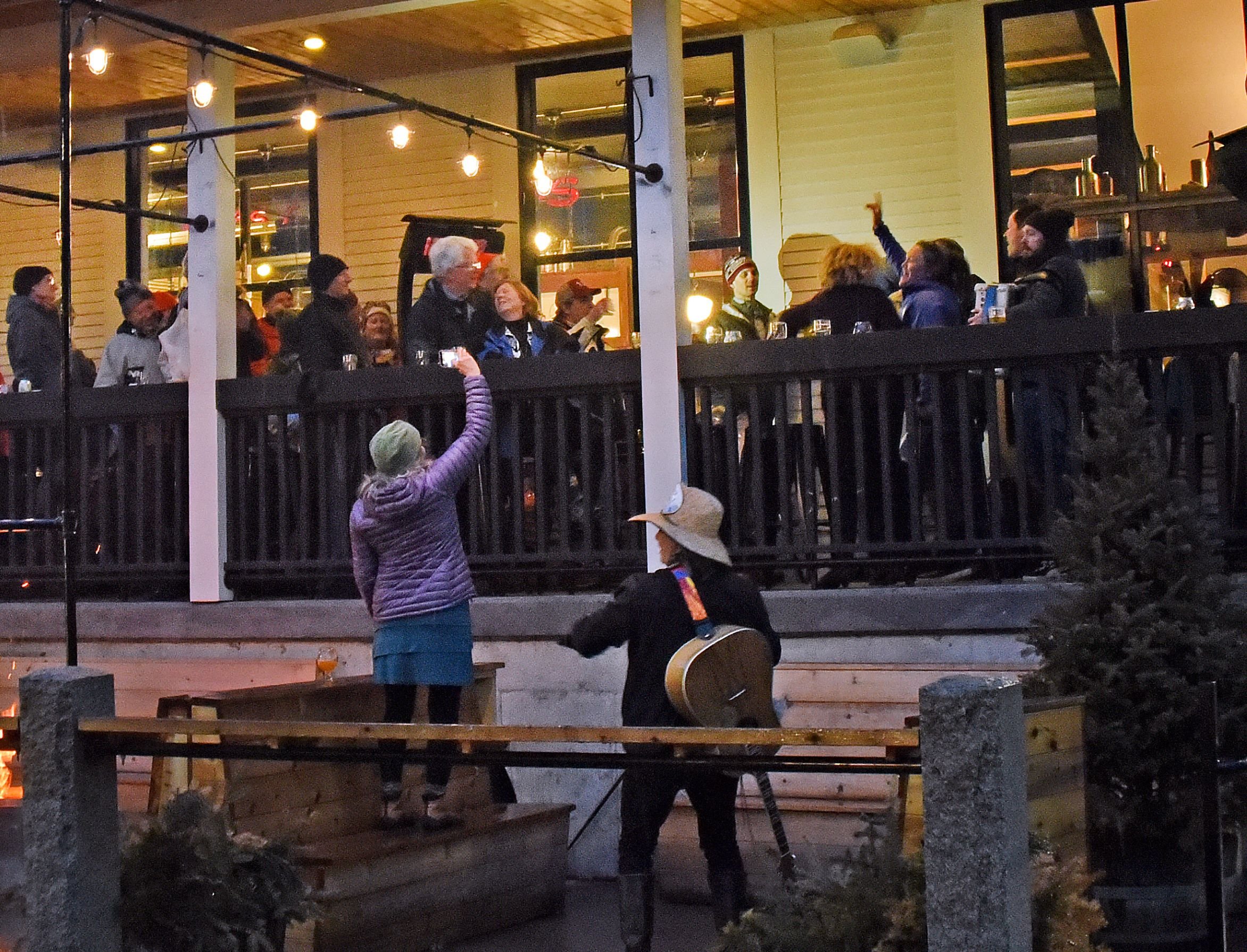  Wassailing event organizers Beth Gilpin (left) and Roger Clapp (right) address the audience gathered on the brewery's covered porch. Photo by Gordon Miller 