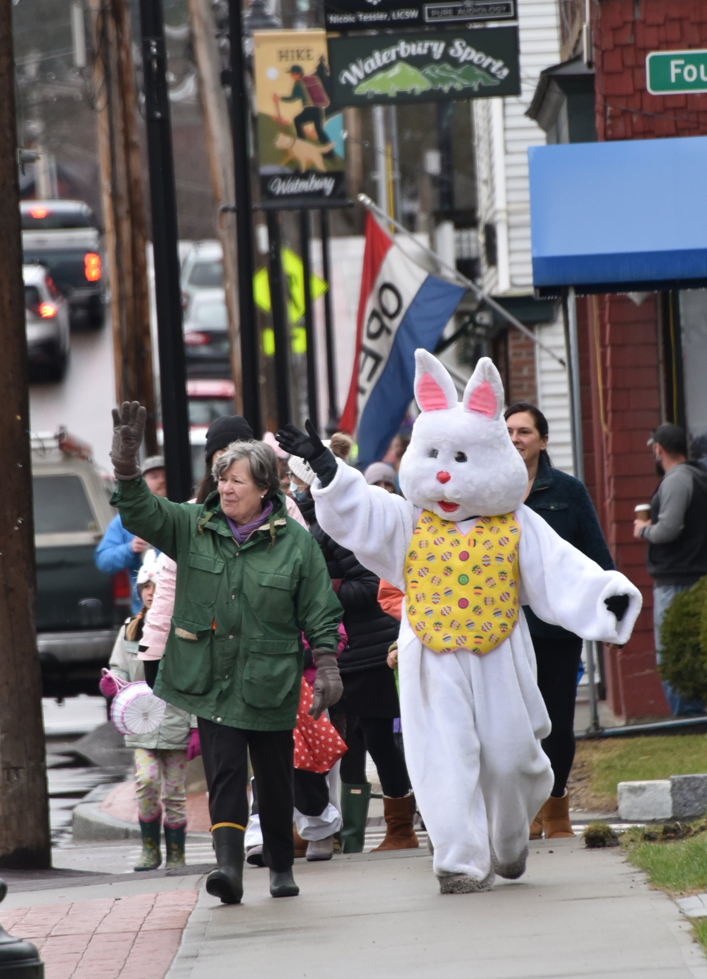  The Easter Bunny gets an escort from Sandy Lewis as the parade makes its way down Main Street. Photo by Gordon Miller 