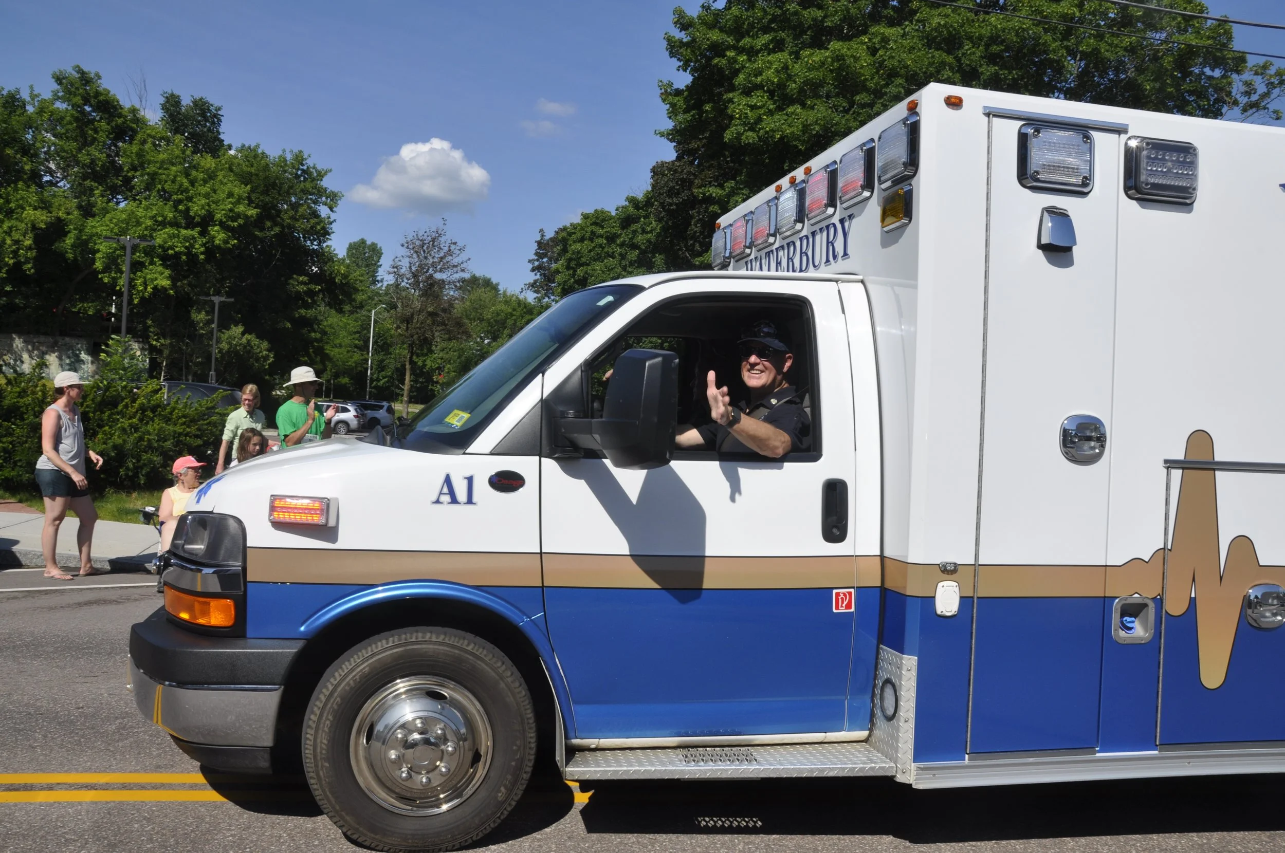  Keith Marino with Waterbury Ambulance Service waves to the crowd. Photo by Lisa Scagliotti 