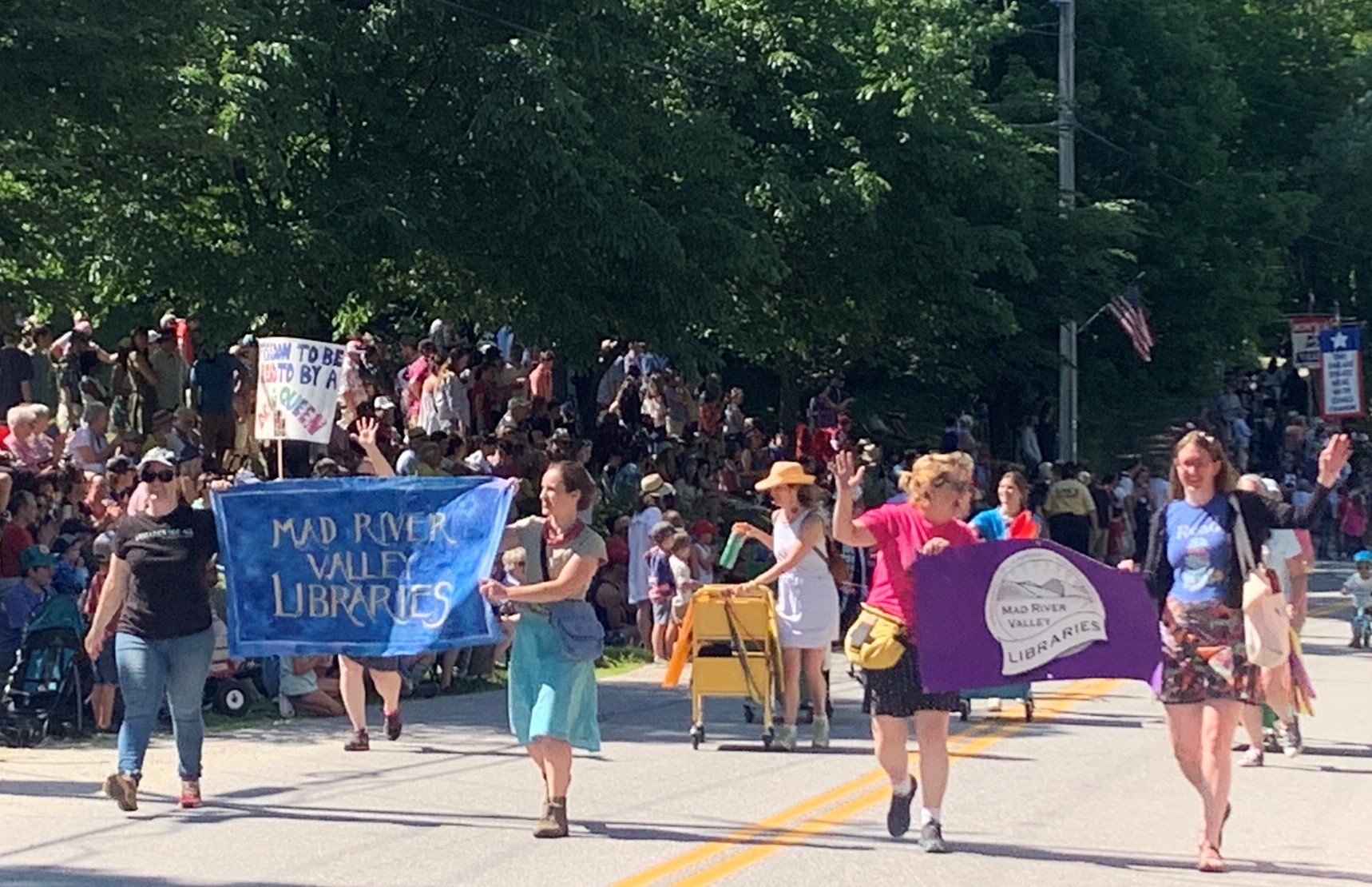  The crowd cheers for the popular community libraries entry with choreographed library carts. 